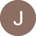 A brown circle with the letter J in the center