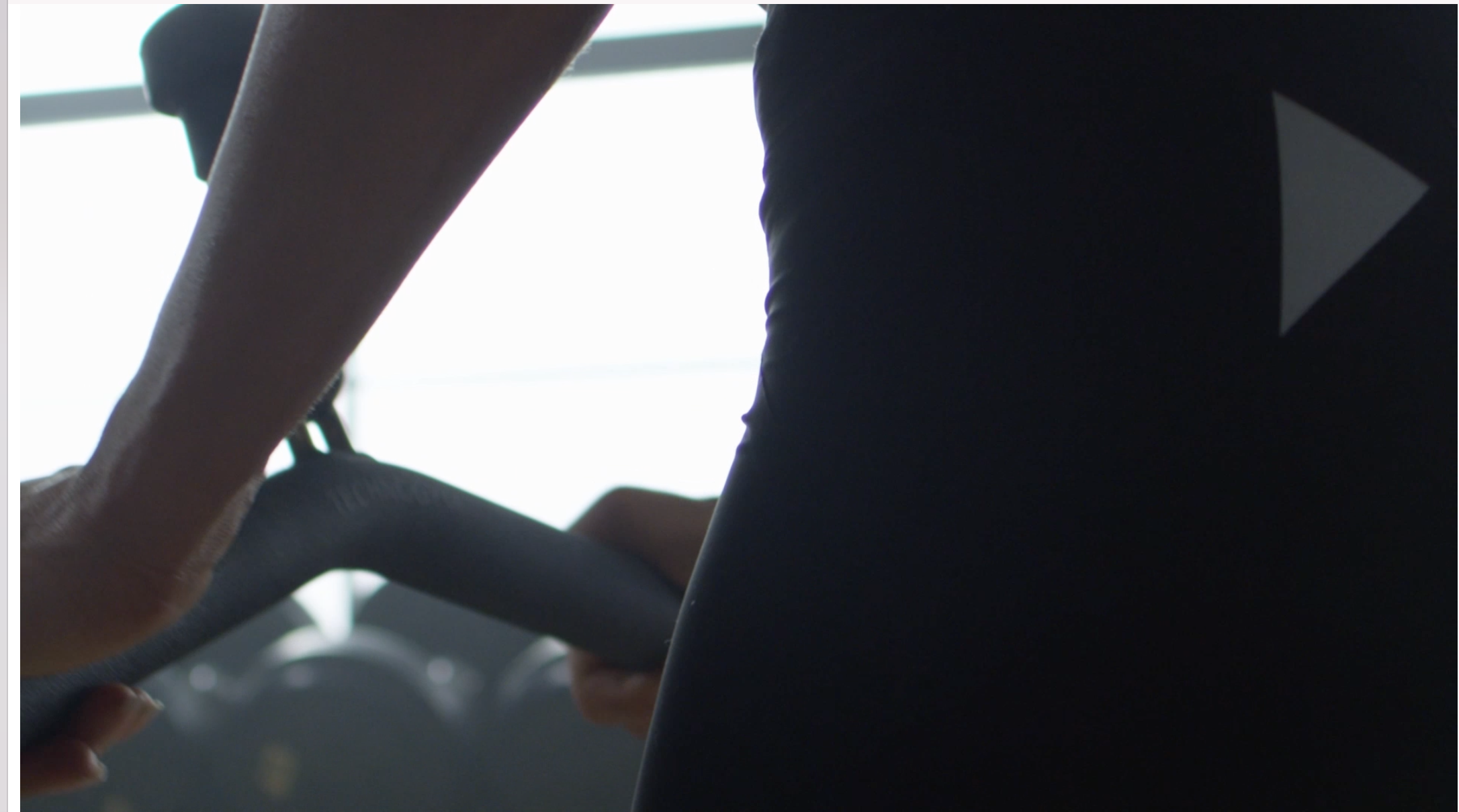 Person holding a steering wheel with a dashboard visible in the background.