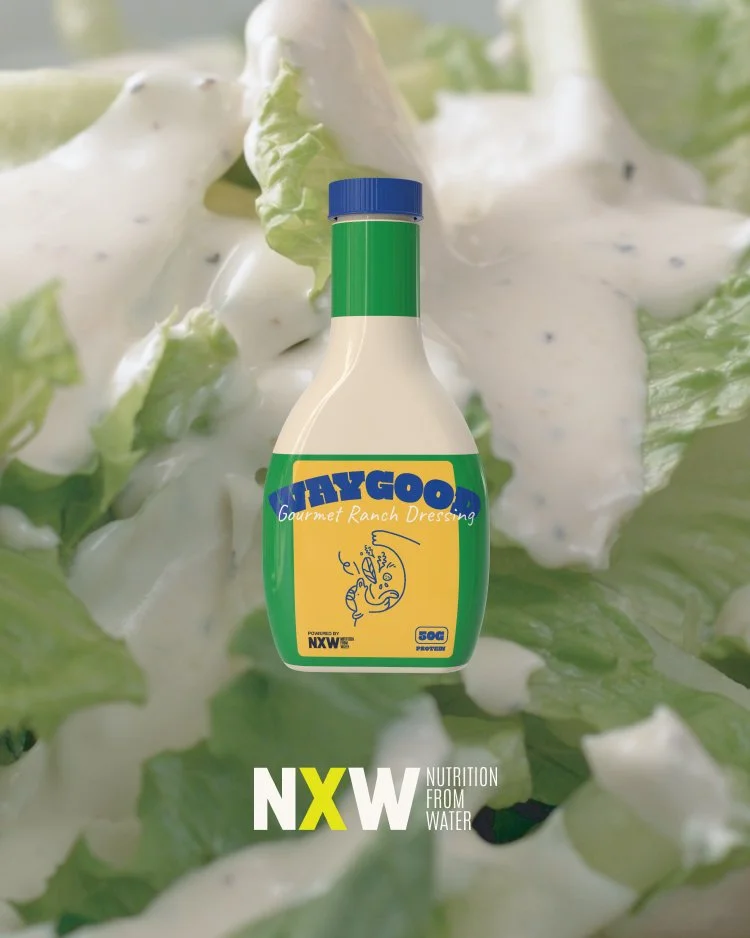 A bottle of WayGood Gourmet Ranch Dressing with a background of chopped lettuce and dressing.