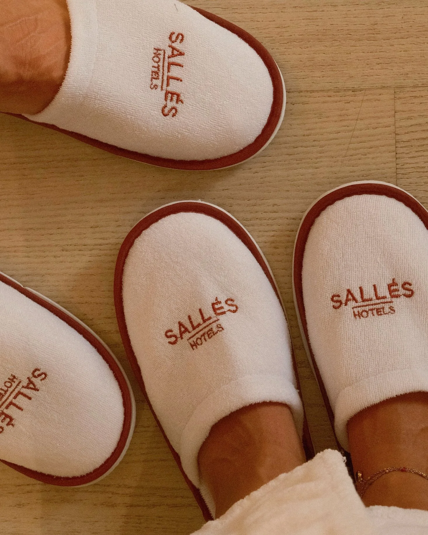 Branded Sallés Hotels slippers prepared inside a contemporary guest room