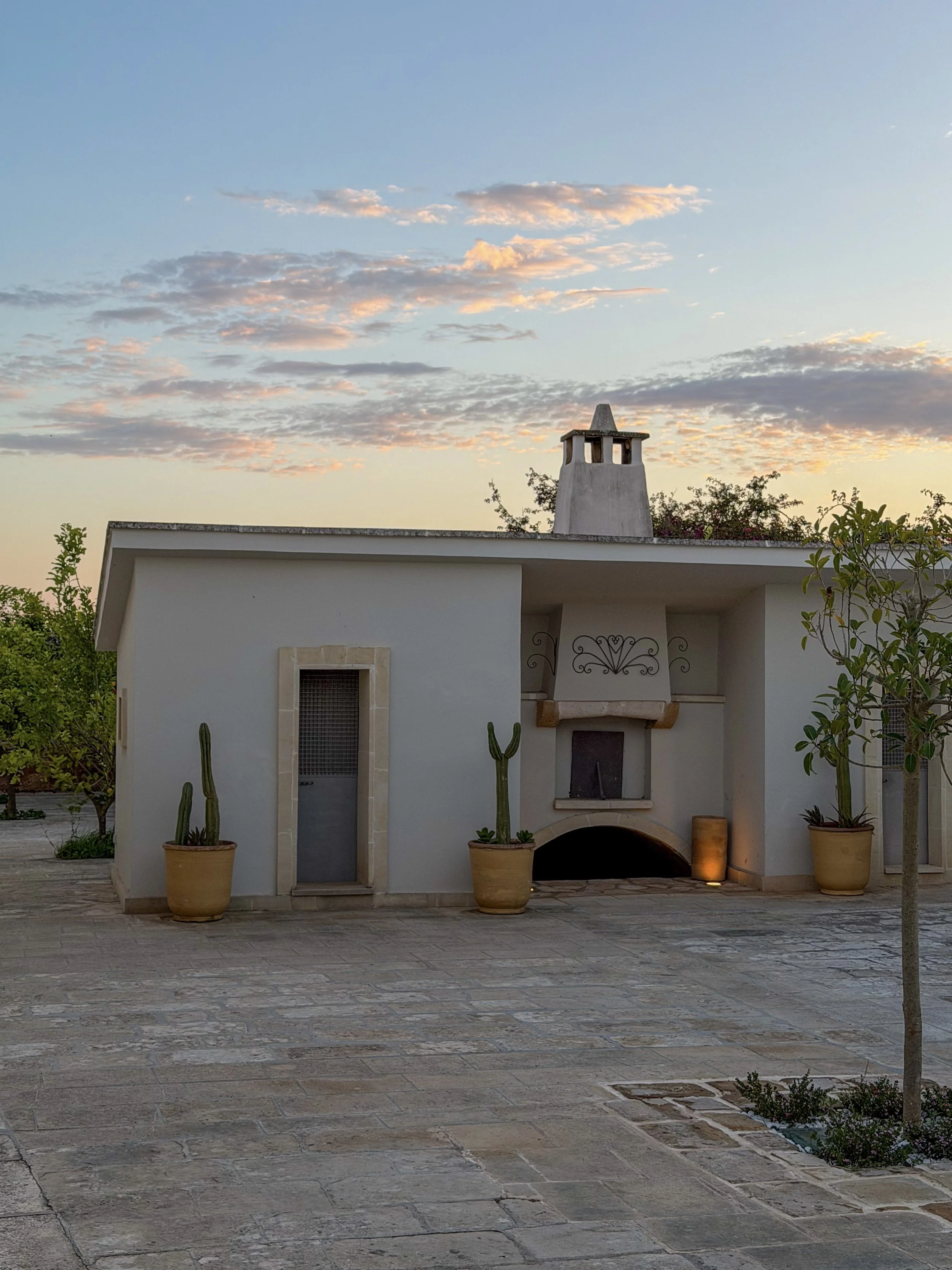 Peaceful courtyard terrace with traditional Apulian architecture at sunset at Tenuta Monacelli Lecce