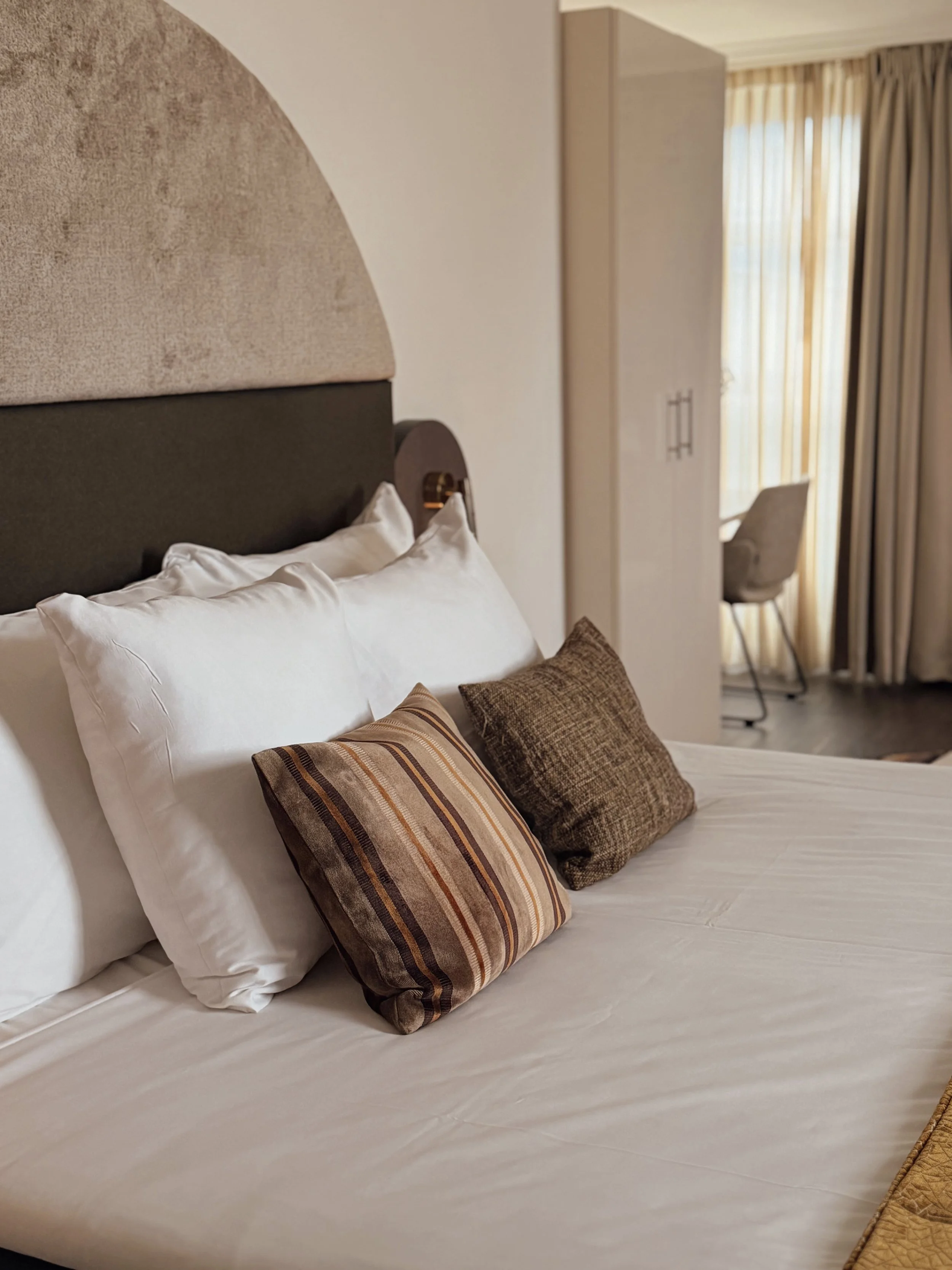 Contemporary guest room with plush king bed and modern furnishings