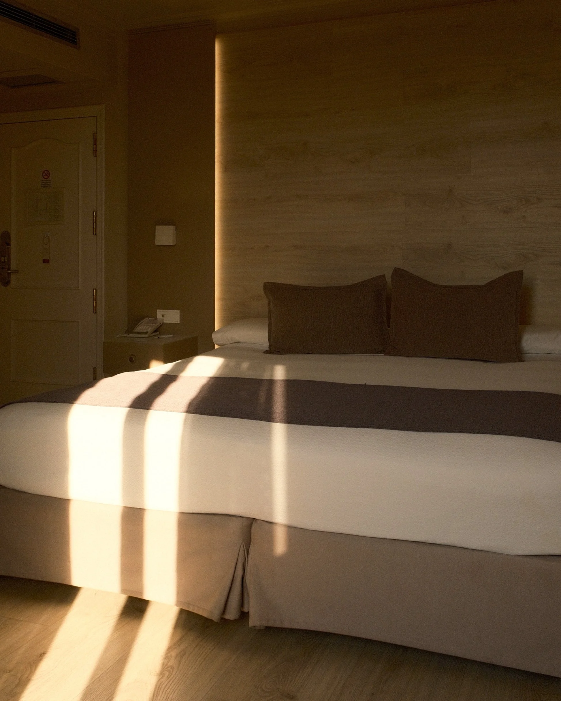 Contemporary guest room illuminated by warm afternoon sunlight