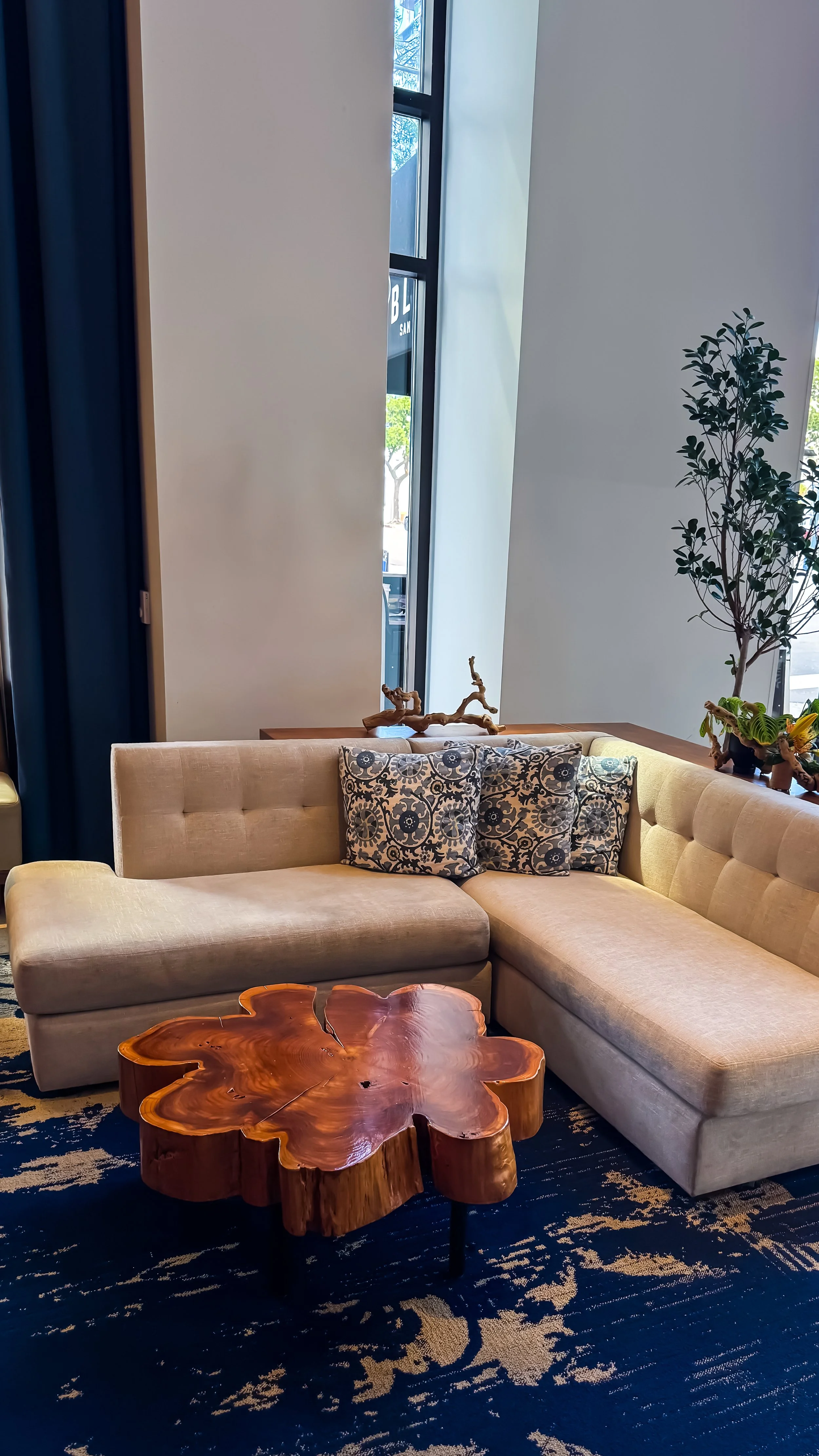 Contemporary lounge corner featuring handcrafted wood furniture, plush seating, and elegant décor