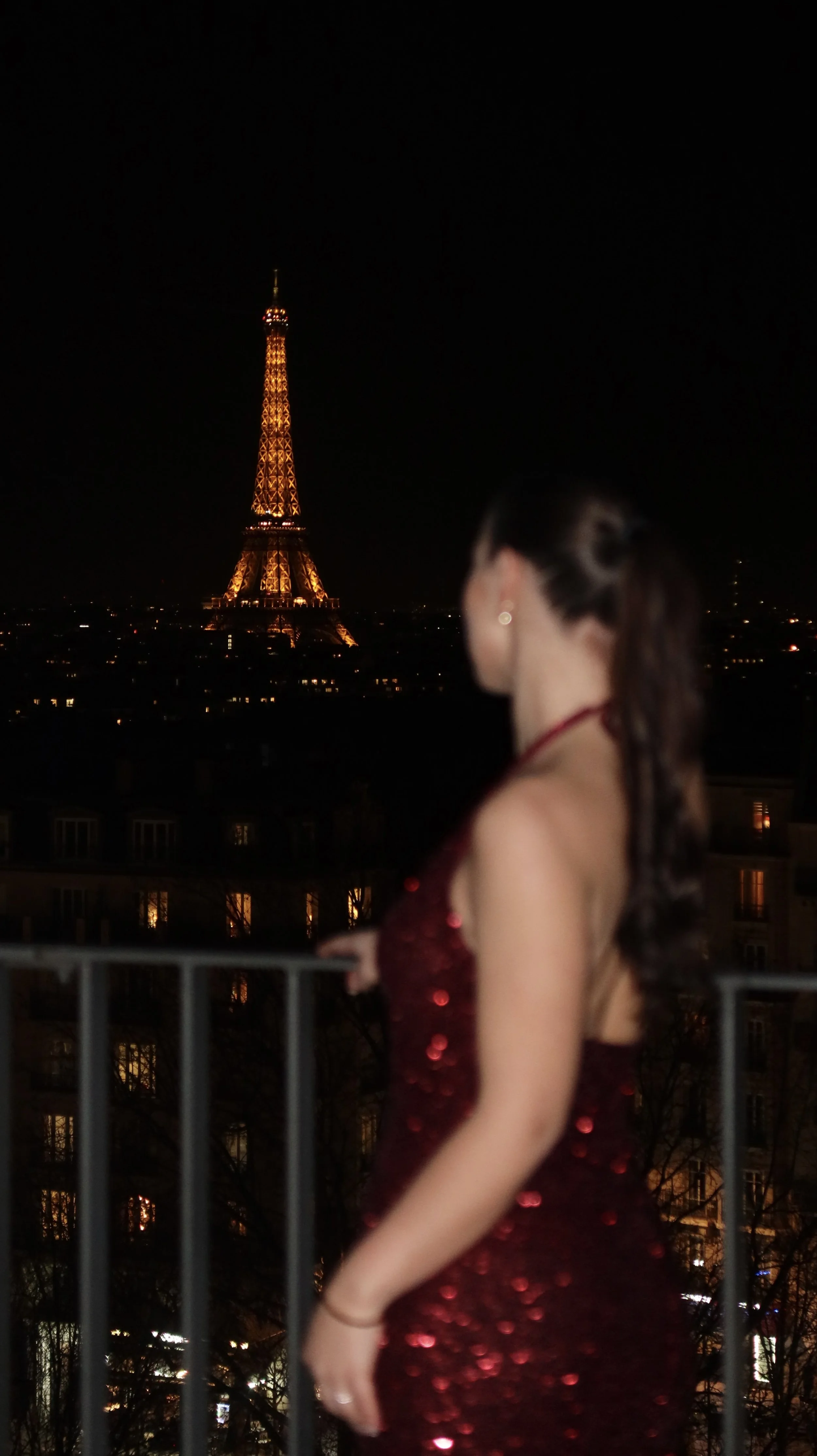 Nighttime balcony moment overlooking the Eiffel Tower glowing above the Paris skyline, Novotel Paris Porte de Versailles – Paris, France.
