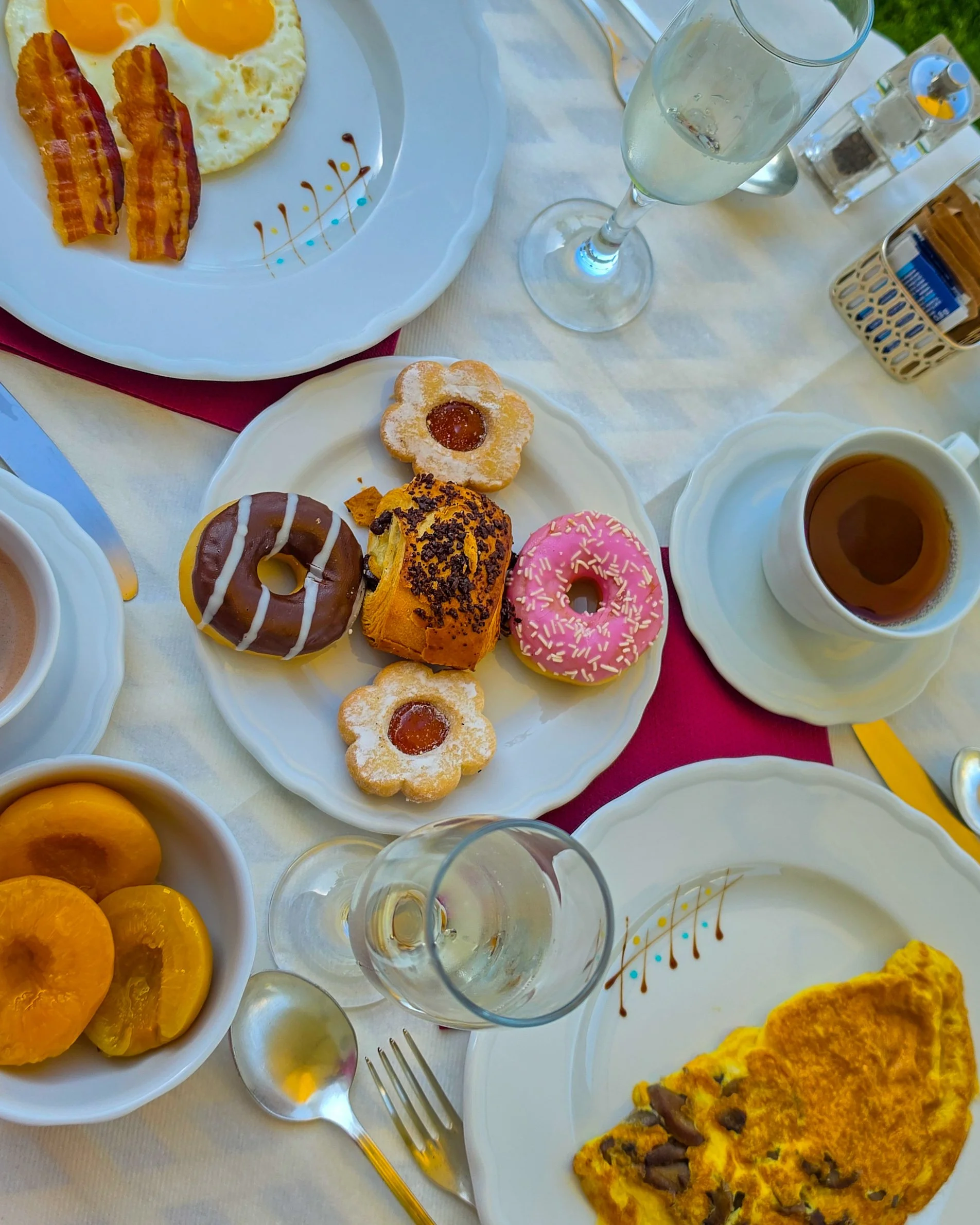 Luxury breakfast featuring freshly prepared eggs, pastries, fruit, coffee, and sparkling wine