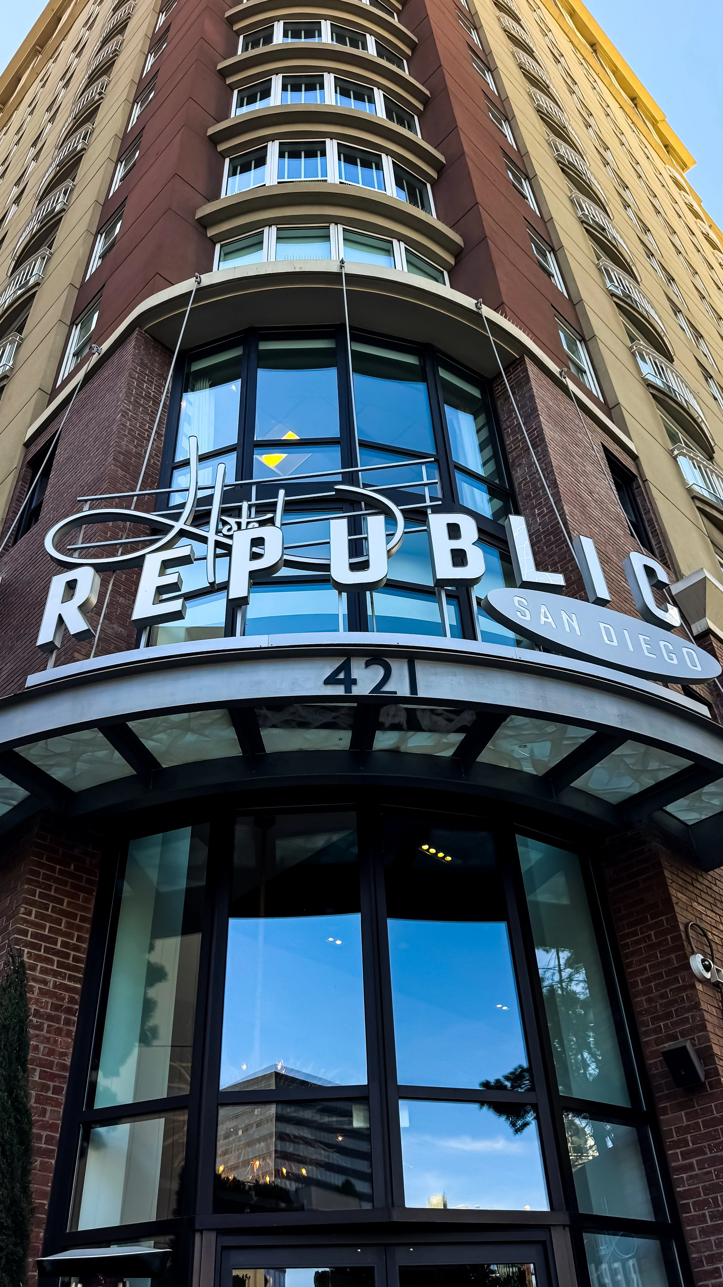 Hotel entrance with bold Republic signage and modern architectural lines in the heart of downtown, Hotel Republic San Diego – San Diego, California.