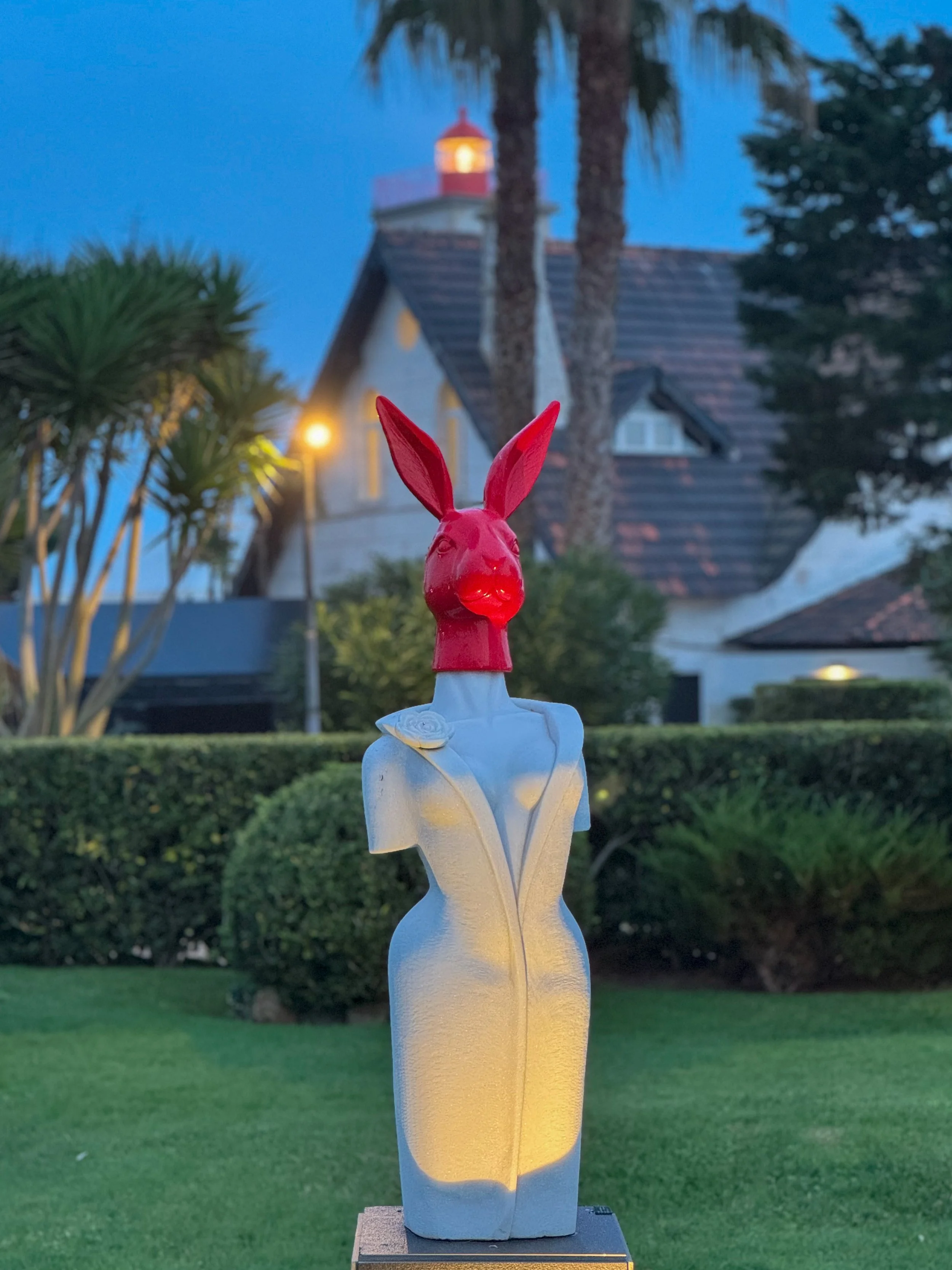 Contemporary rabbit sculpture set within Farol Hotel’s landscaped gardens at dusk