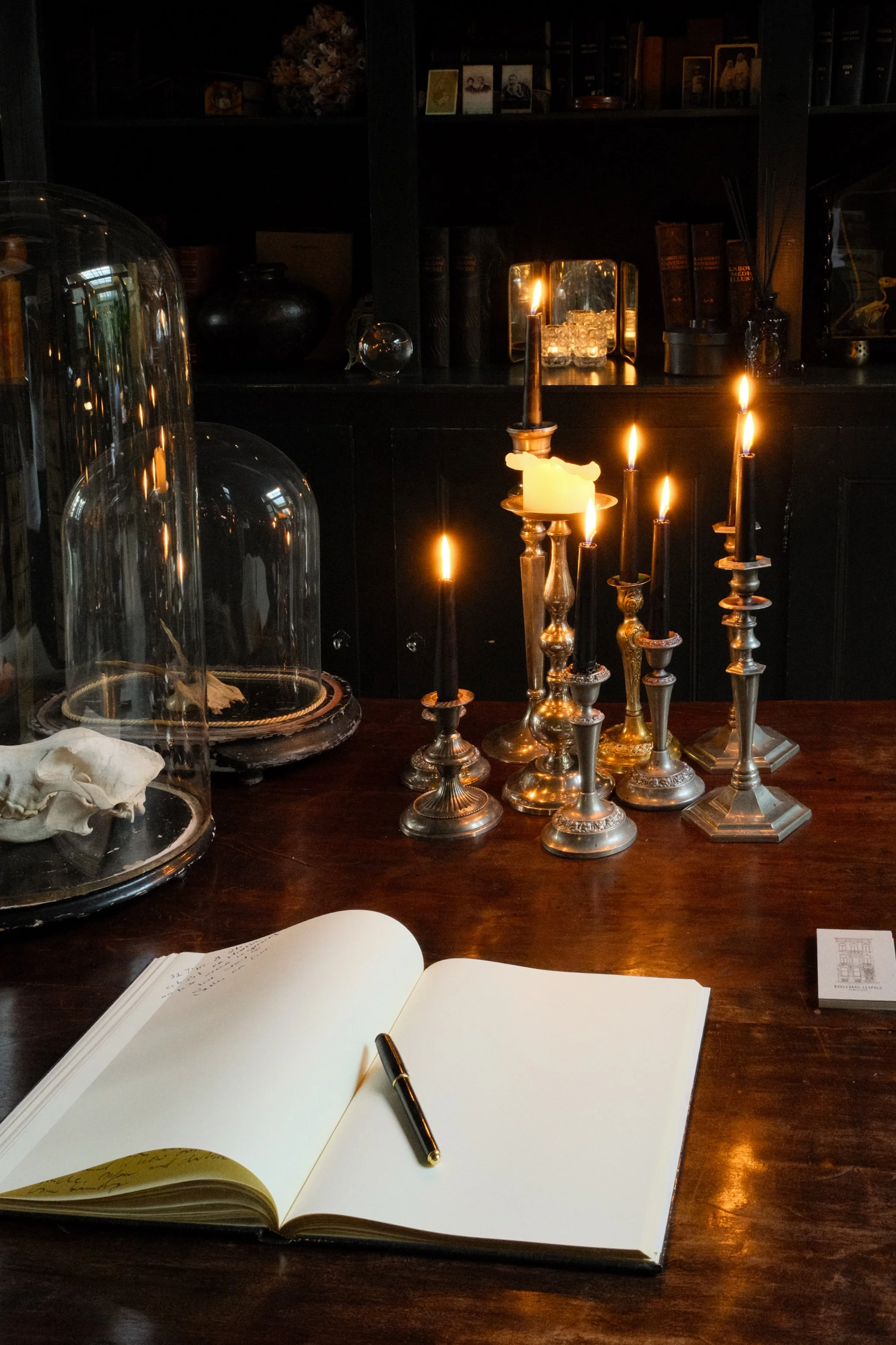 Cozy library corner with candles, antique décor, and guestbook