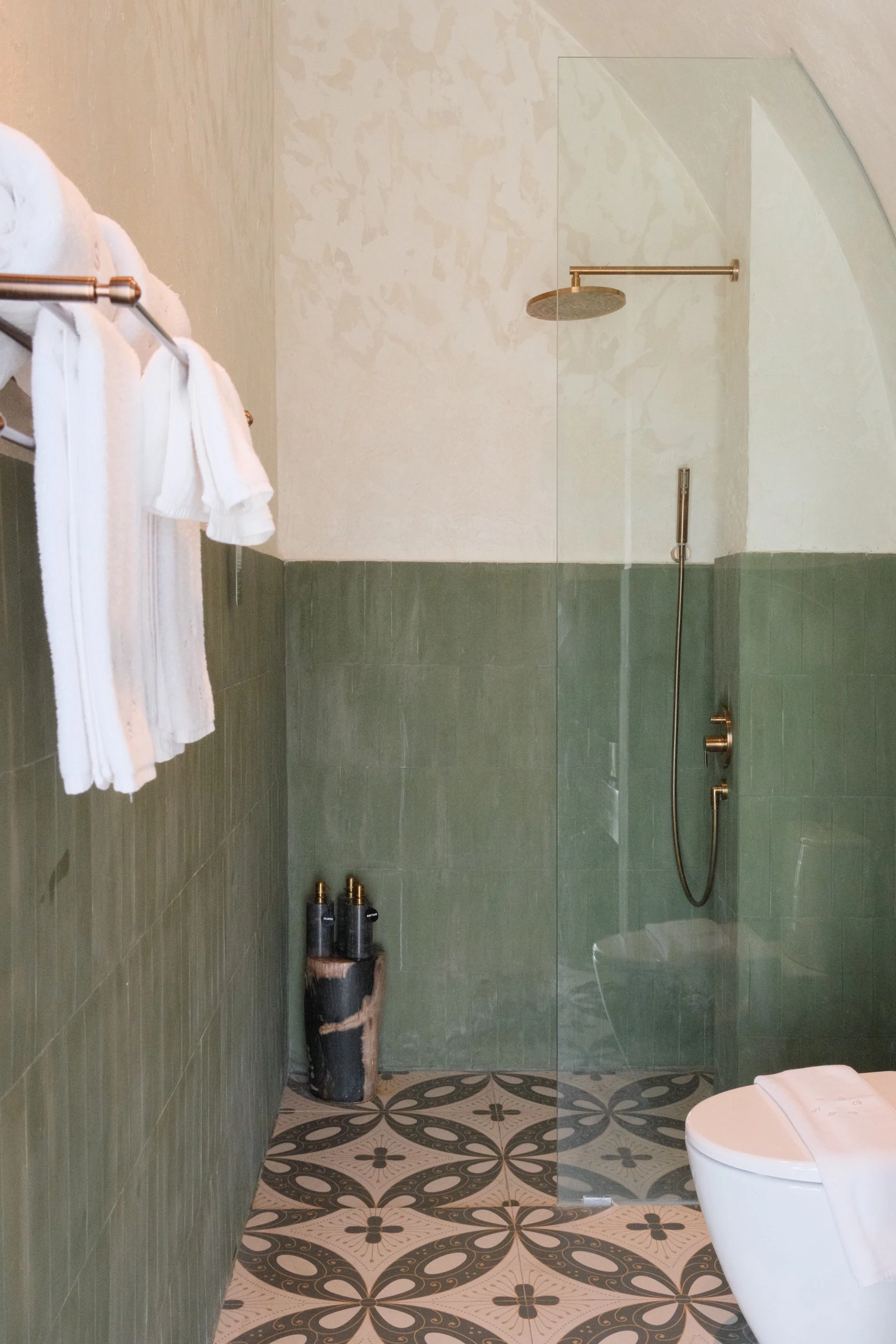 Contemporary bathroom with walk-in rain shower and calming green tile finishes