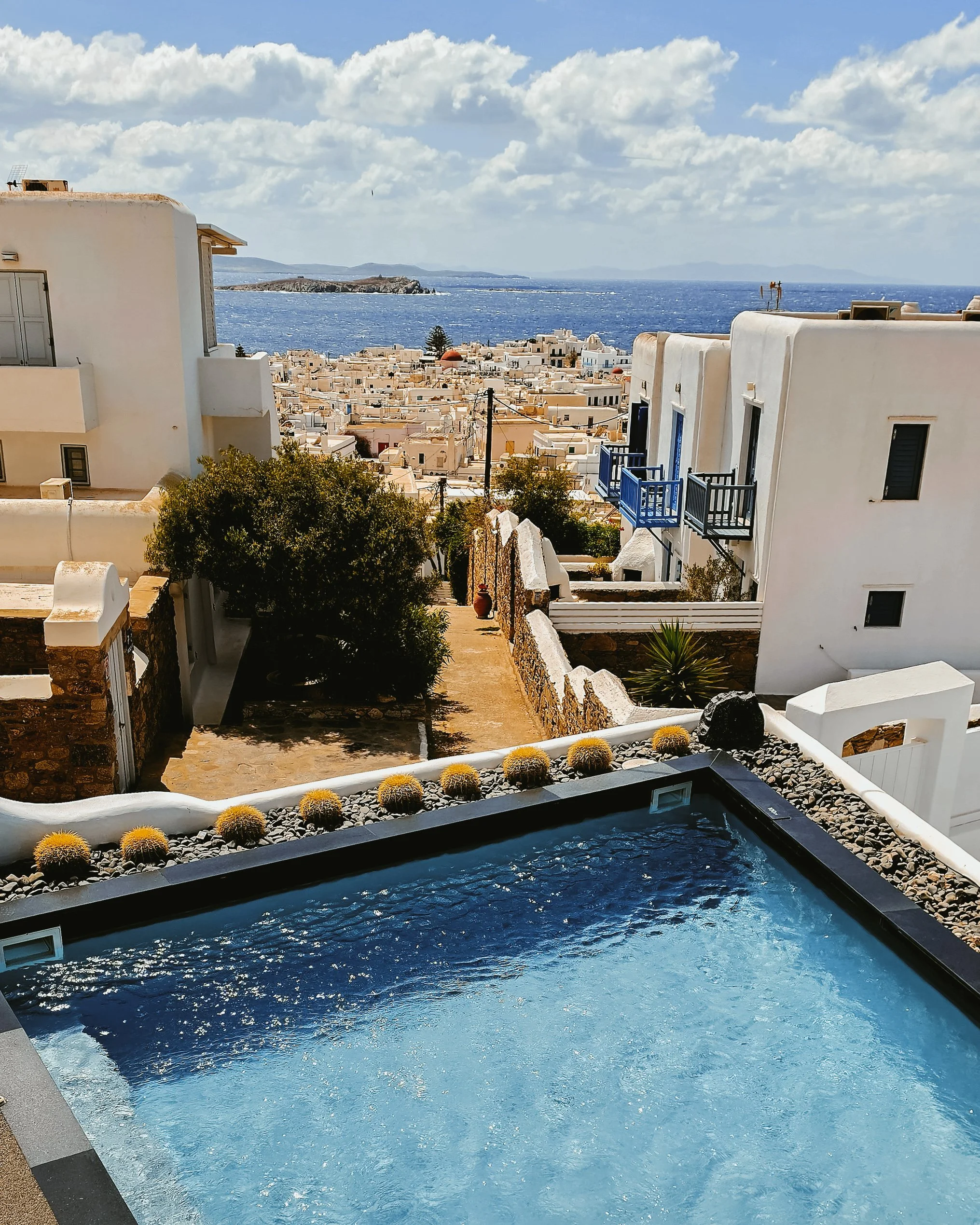 Private jacuzzi overlooking Mykonos Town, the sparkling Aegean Sea, and iconic Cycladic architecture