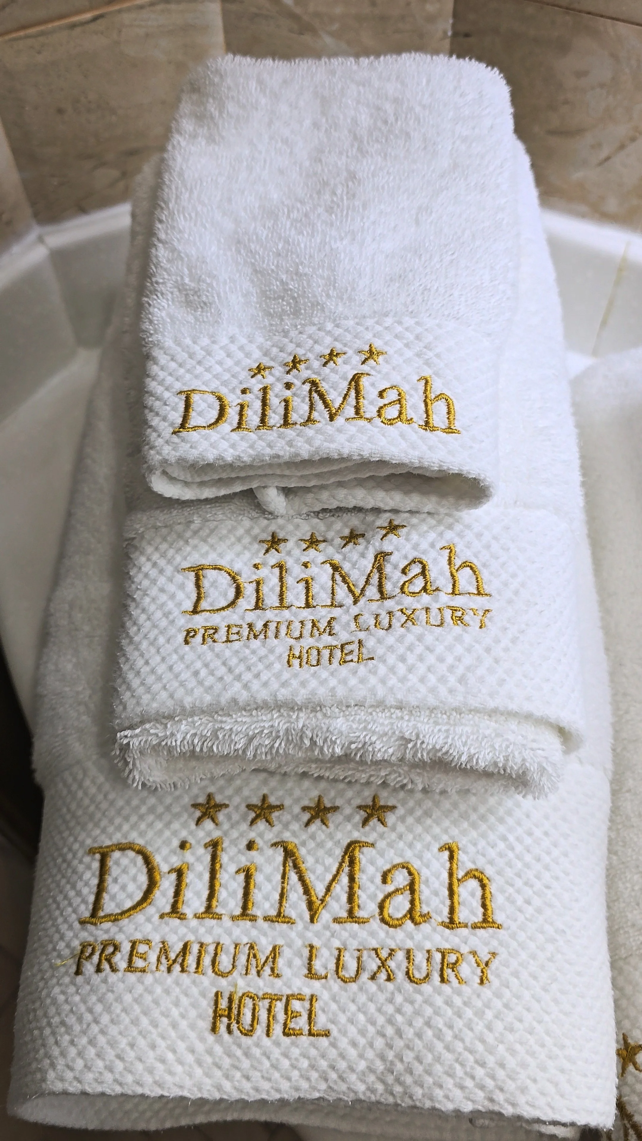 Luxury embroidered towels prepared for guests with premium hospitality details