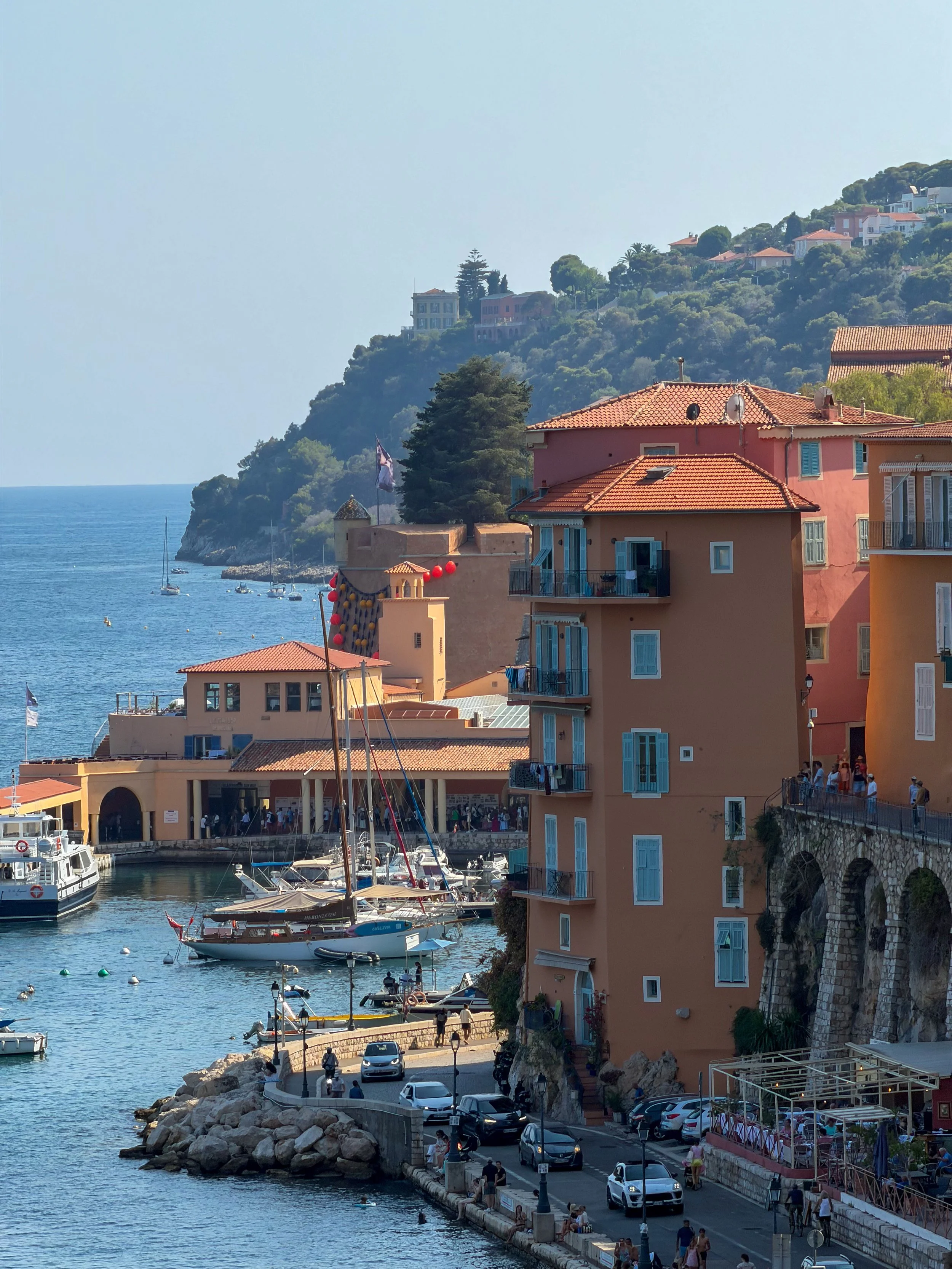 Colourful harbour lined with pastel buildings and traditional Mediterranean architecture