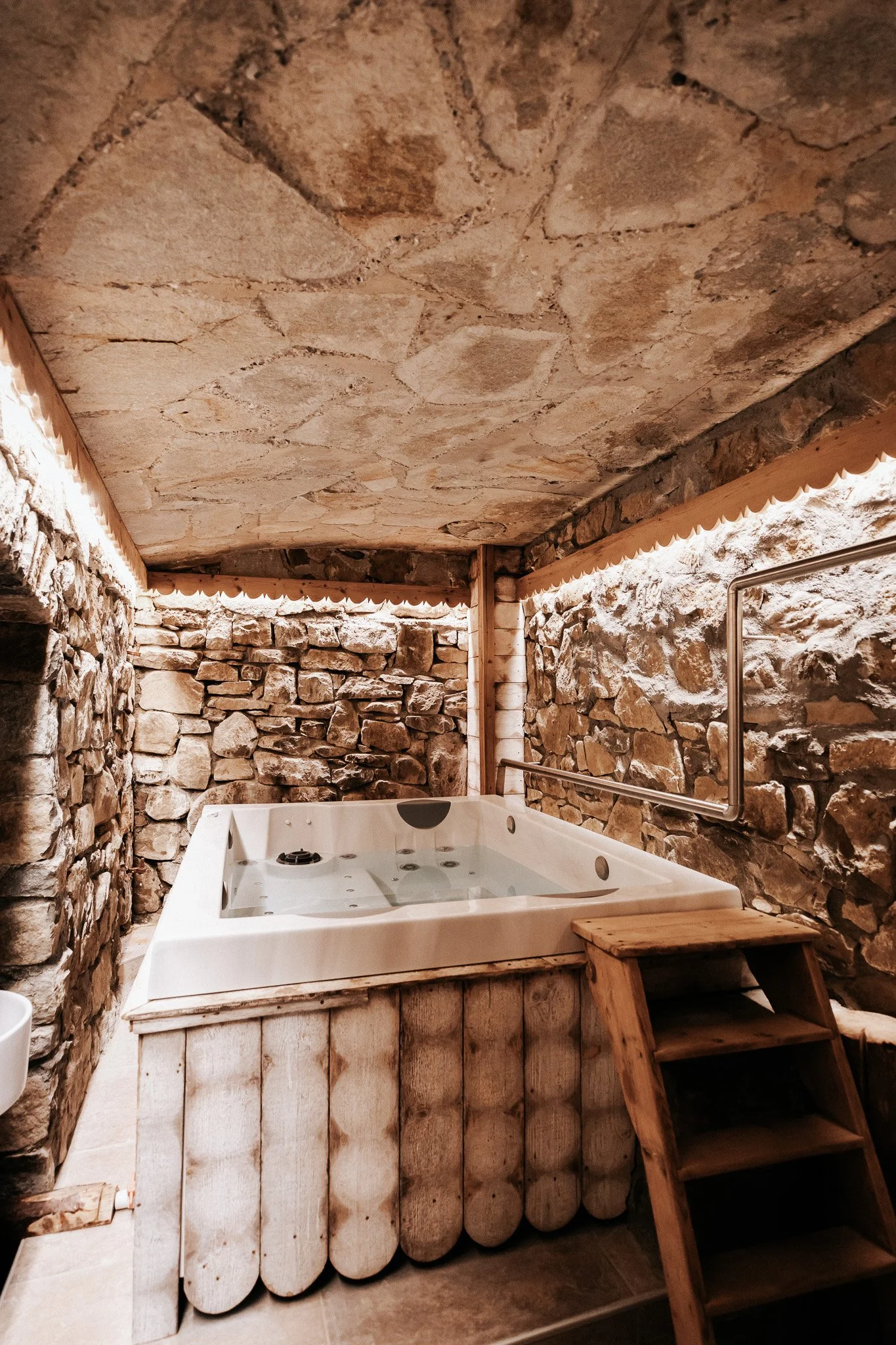 Private indoor jacuzzi in a stone-walled room at Le Hameau de Mon Père – Les Gets, France