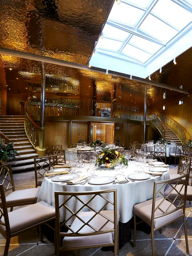 Grand event space with sweeping staircases and skylight aboard Fingal Hotel in Edinburgh