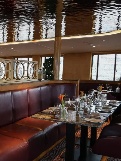 Refined restaurant interior with polished wood finishes and elegant booth seating aboard Fingal Hotel