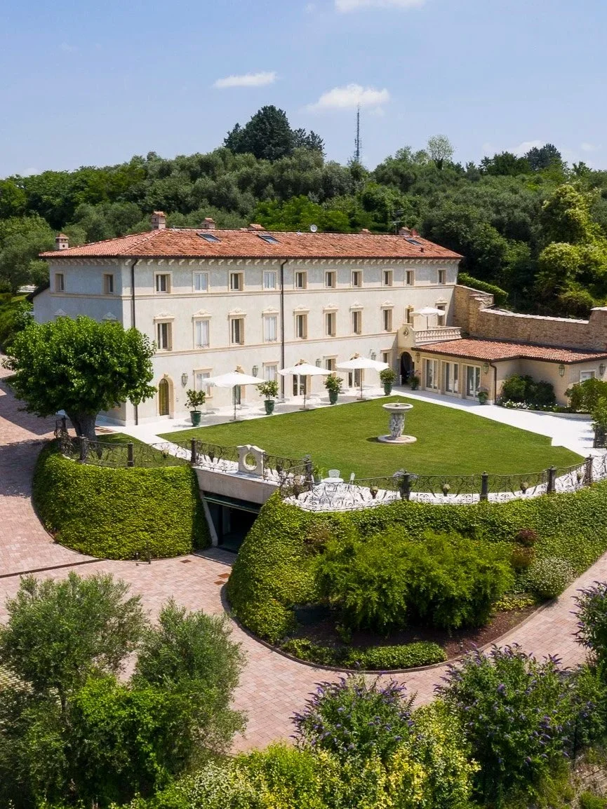 Aerial view of Relais Fra’ Lorenzo showcasing its historic villa, manicured gardens, and peaceful setting above Verona
