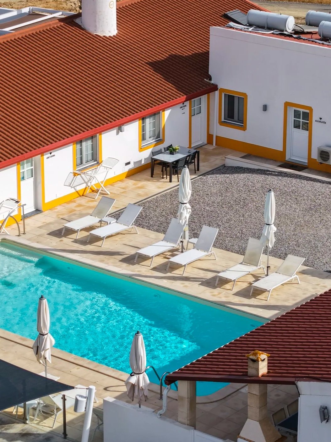 Aerial view of the resort’s outdoor swimming pool, accommodation, and sun terrace