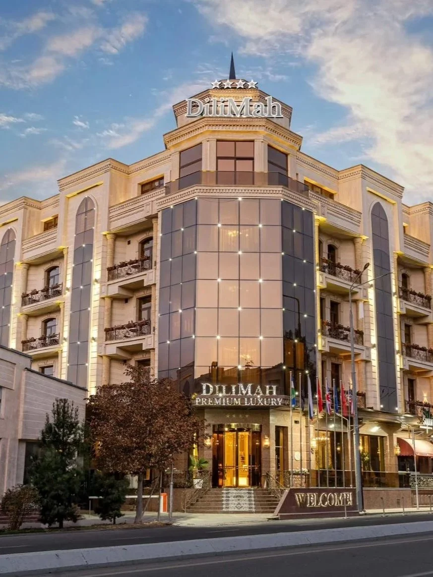 Elegant hotel façade illuminated at sunset showcasing timeless architecture in the heart of Samarkand