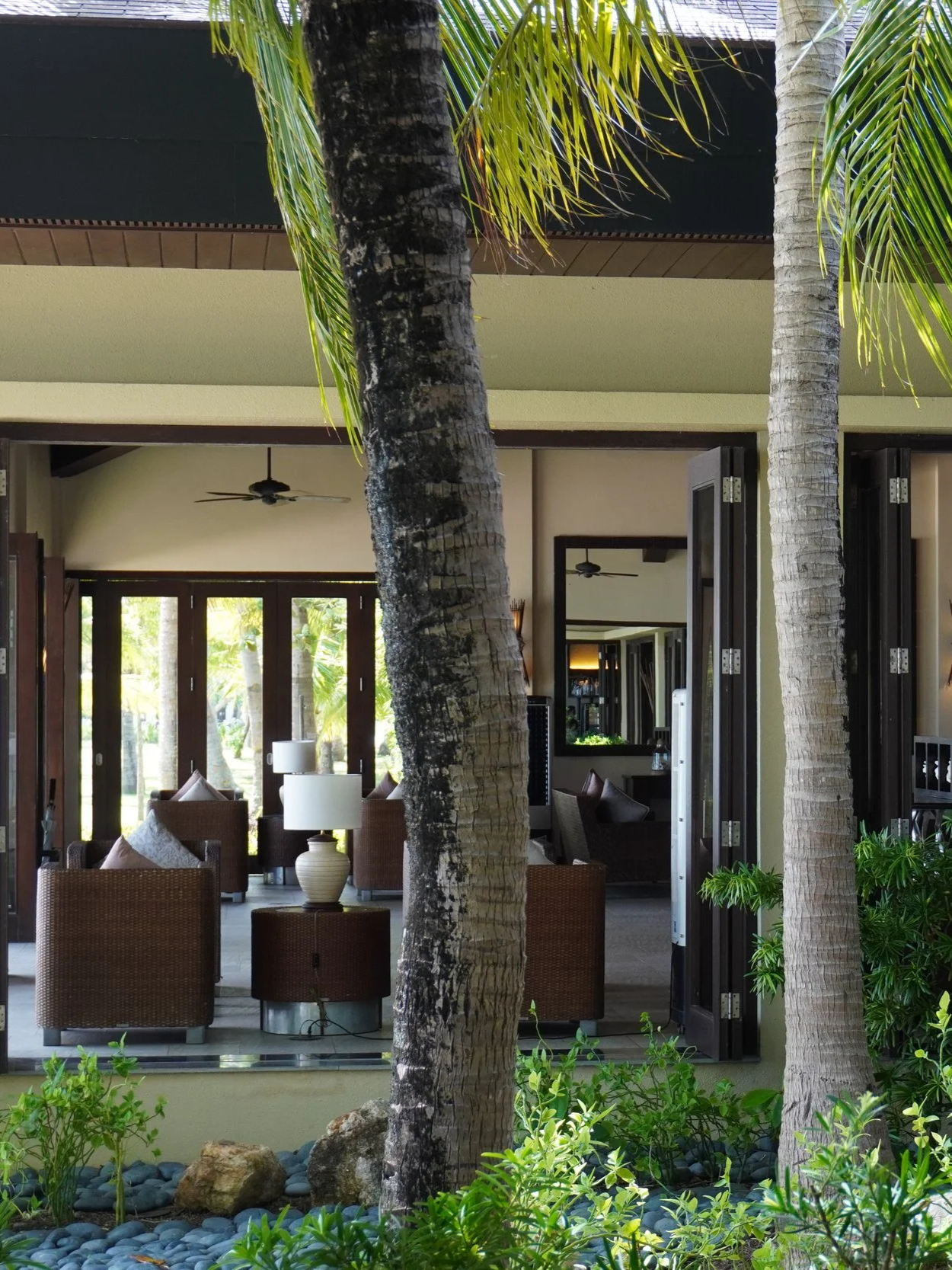 Open-air resort lobby blending contemporary tropical architecture with natural surroundings
