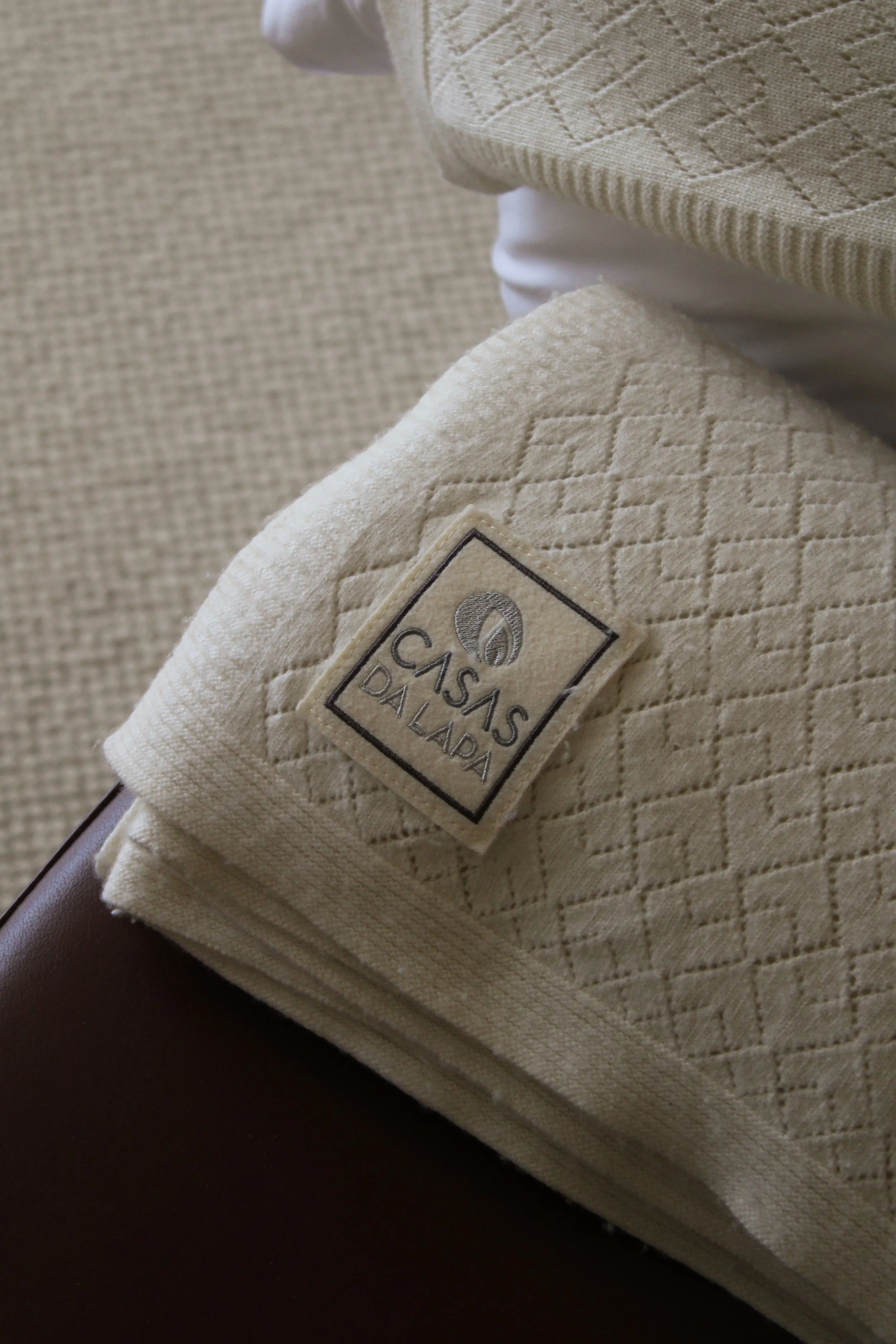 Close-up of embroidered linen detail showcasing craftsmanship at Casas da Lapa in Serra da Estrela, Portugal