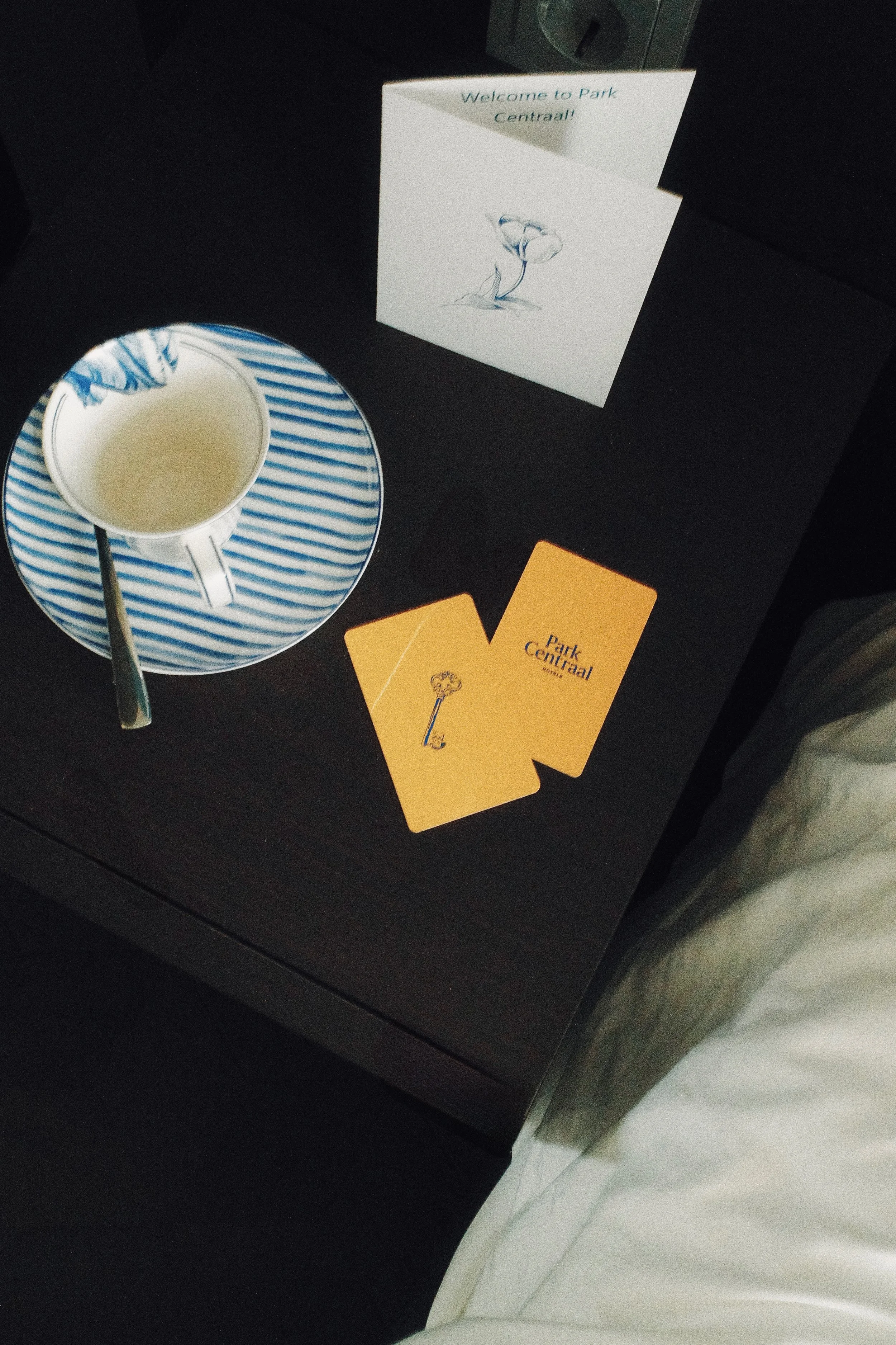 Welcome amenities featuring room key cards, coffee cup, and personalized greeting