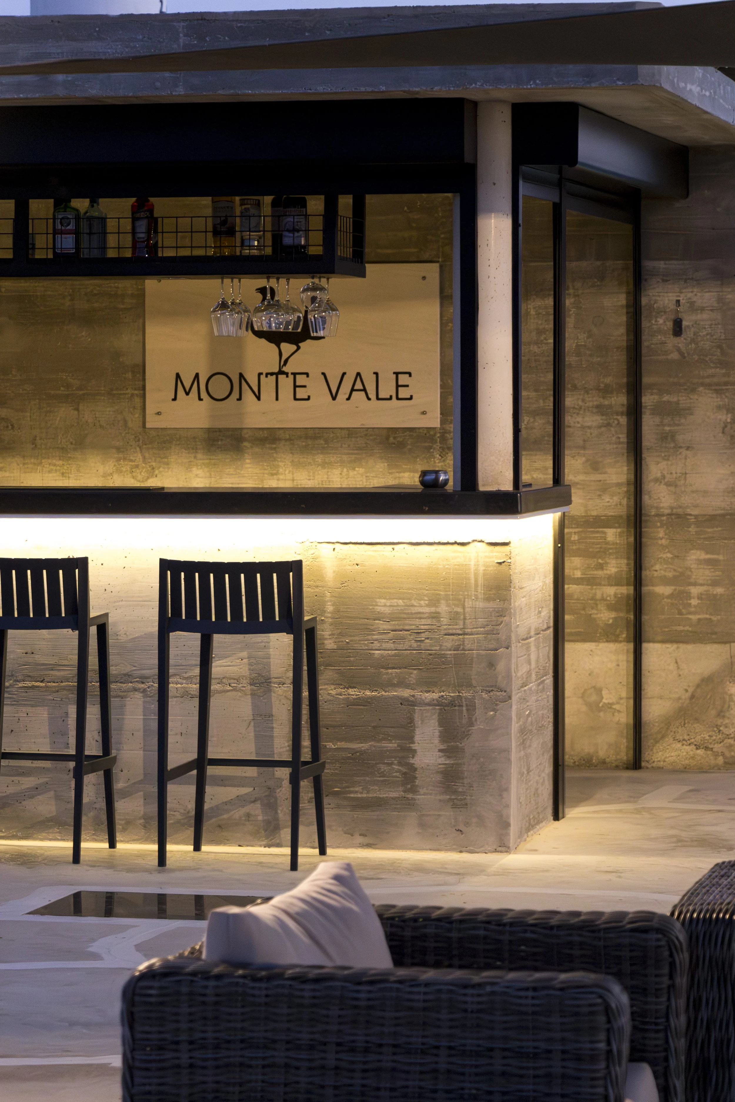 Contemporary outdoor bar overlooking the resort with elegant lighting and relaxed evening atmosphere