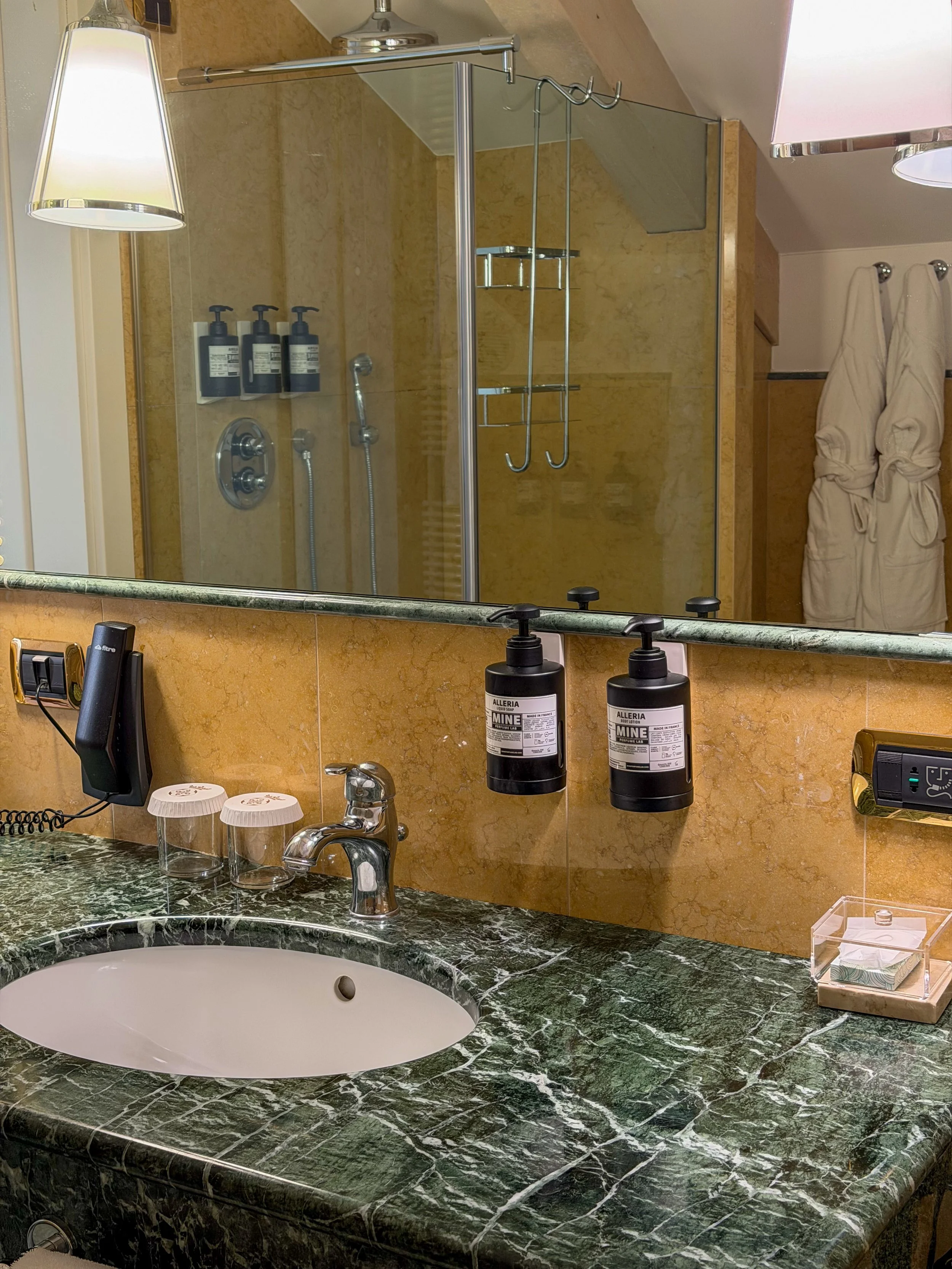 Marble bathroom with premium amenities and spacious rainfall shower