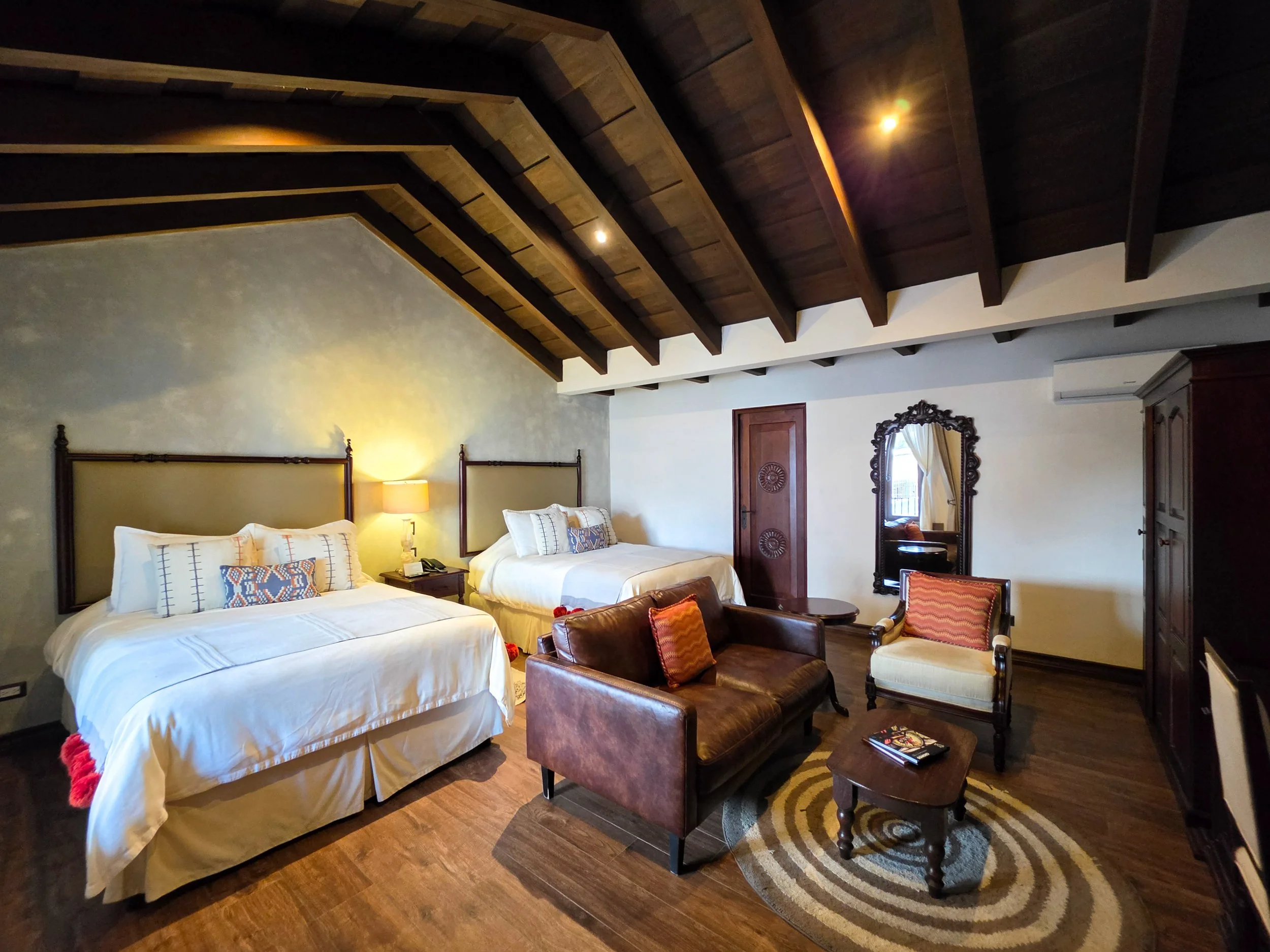 Spacious suite with handcrafted furnishings and exposed wooden beams