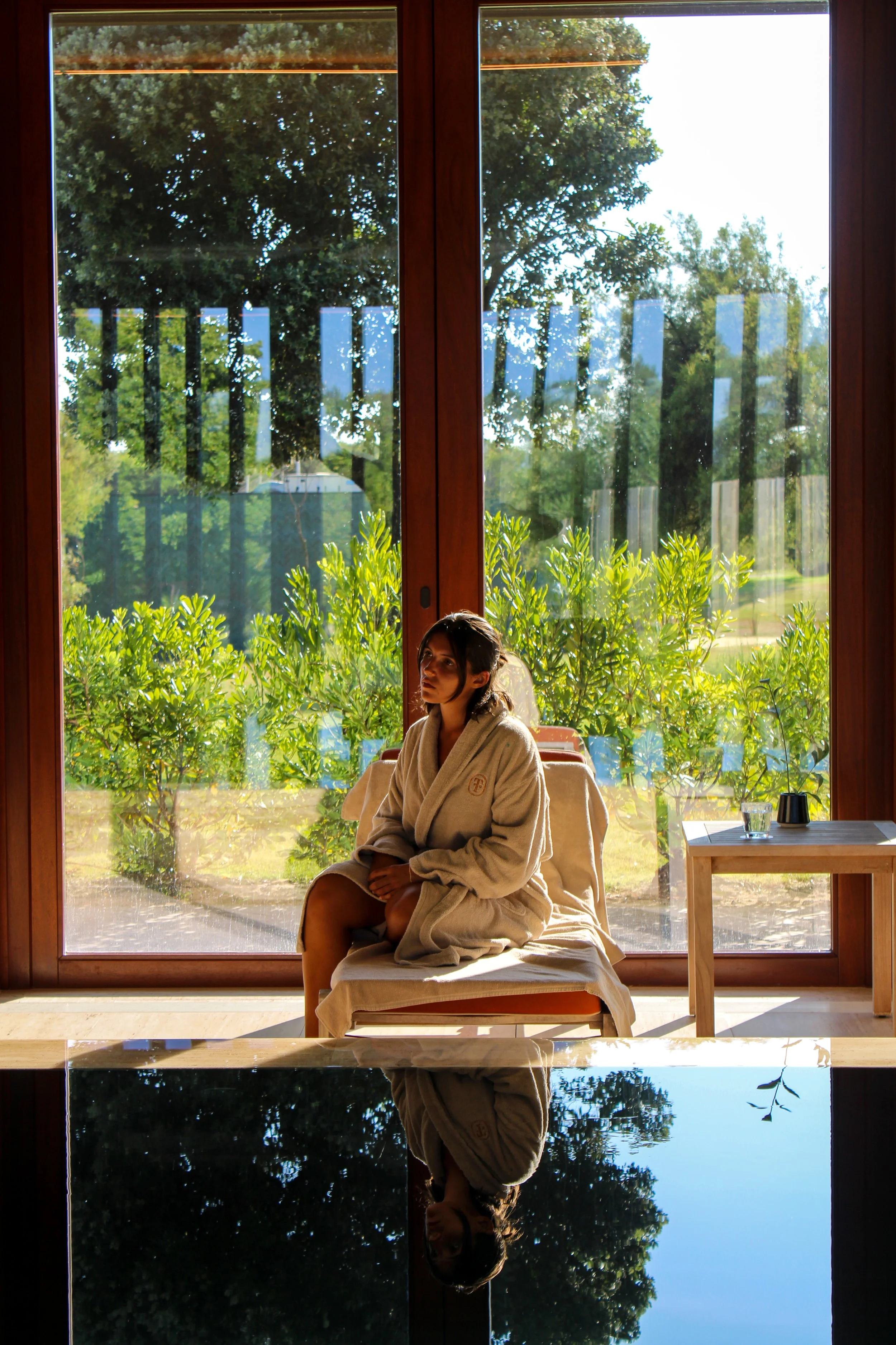 Spa relaxation area with floor-to-ceiling windows overlooking tranquil gardens