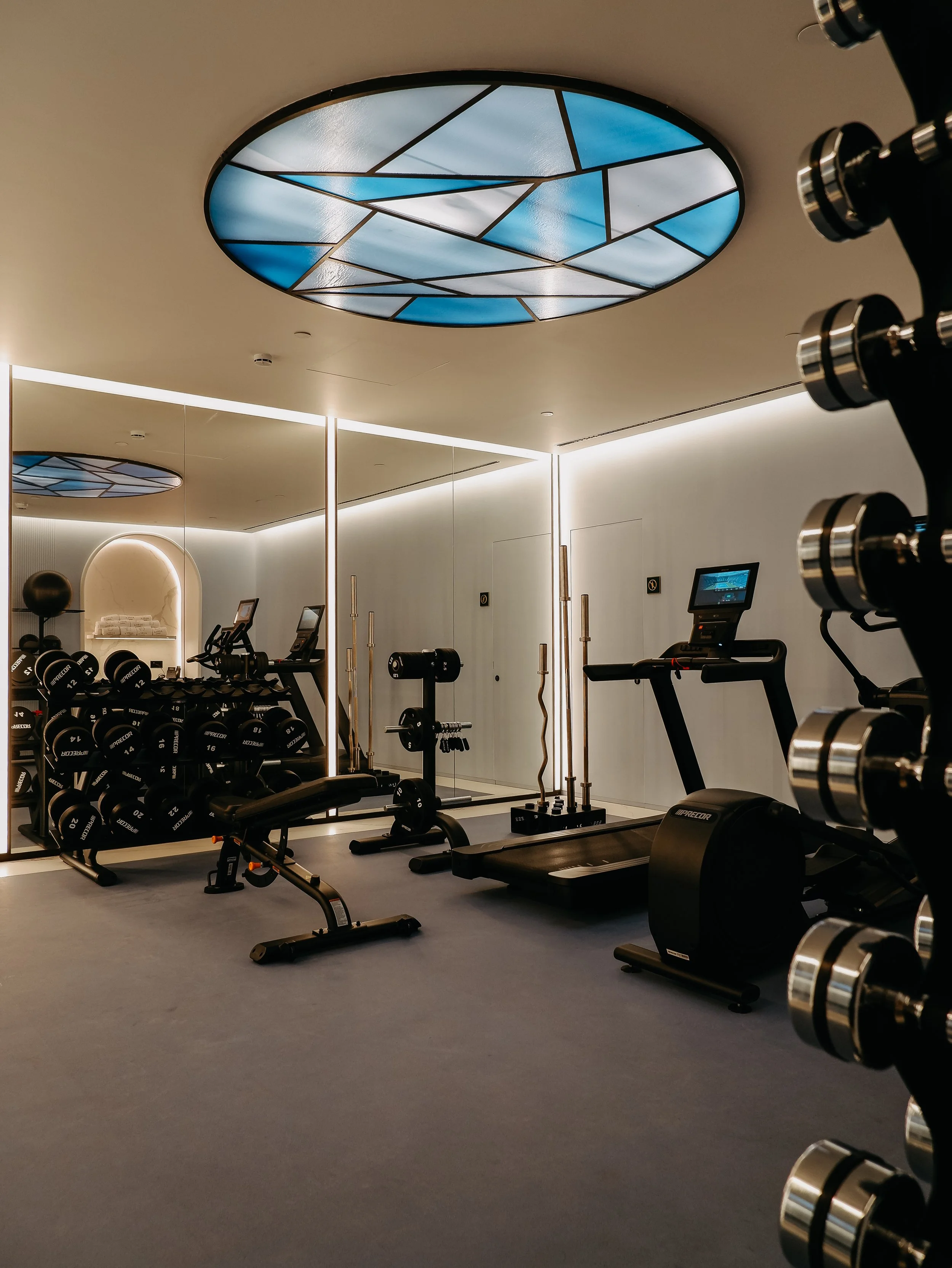 Modern fitness centre equipped with cardio machines and free weights