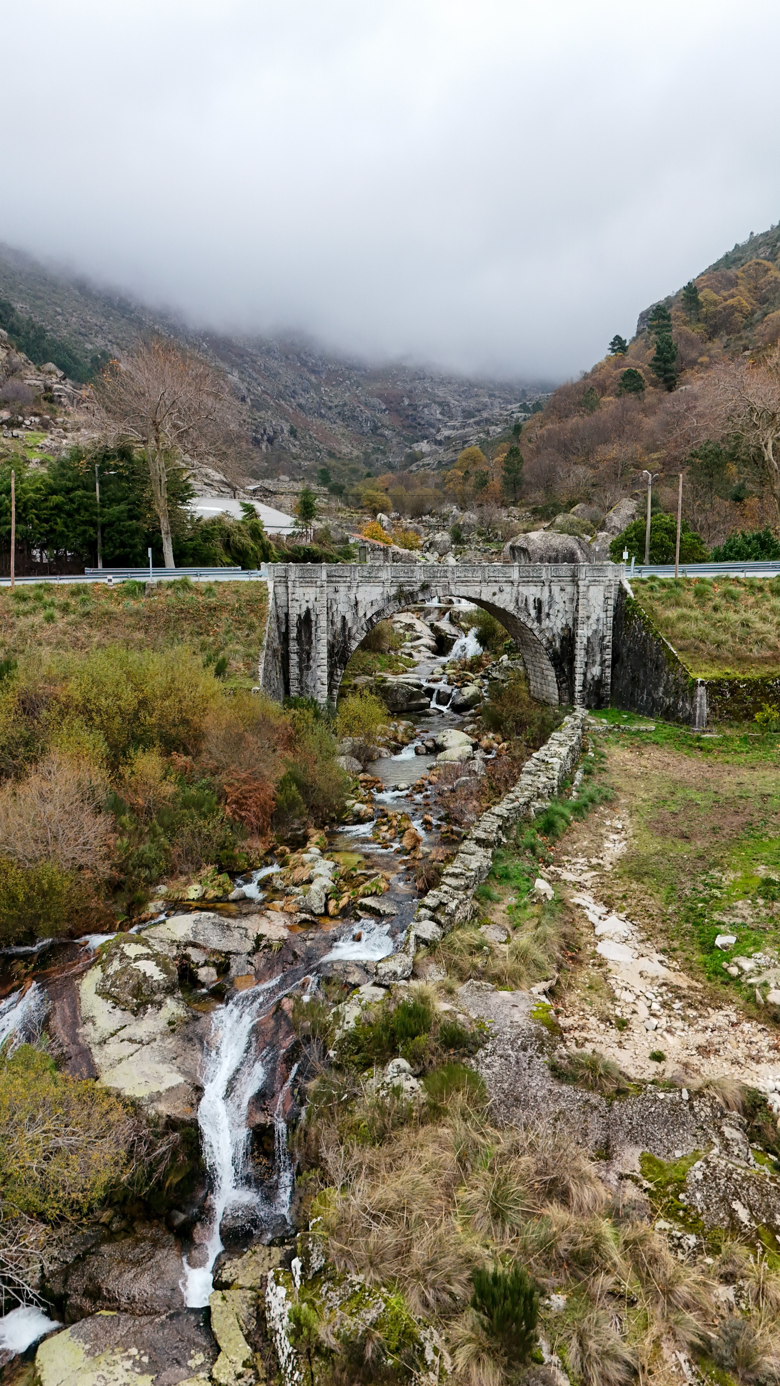 Historic stone bridge crossing a mountain stream in Serra da Estrela Natural Park near Chão do Rio