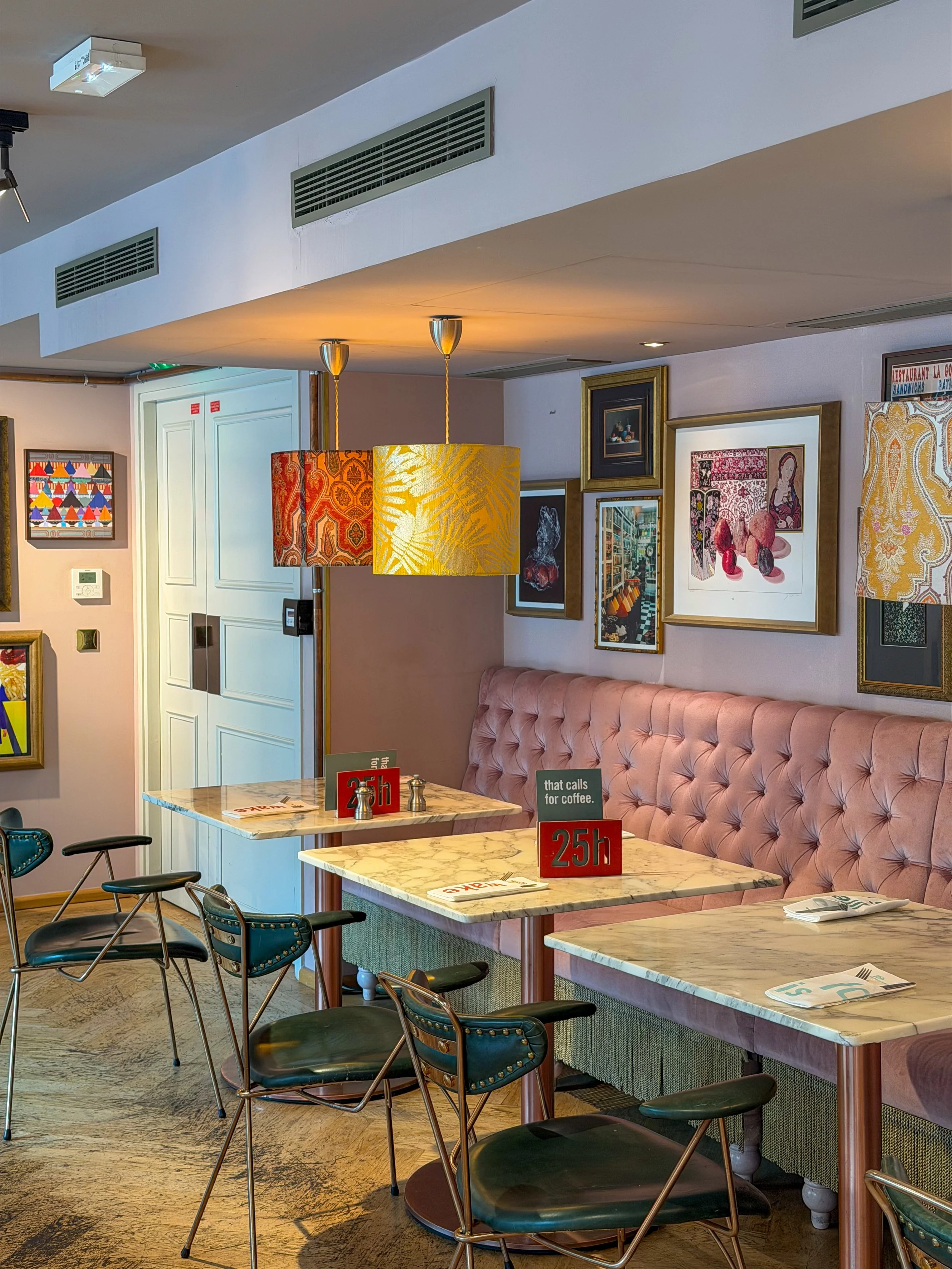 Stylish café seating area blending contemporary furniture with curated artwork