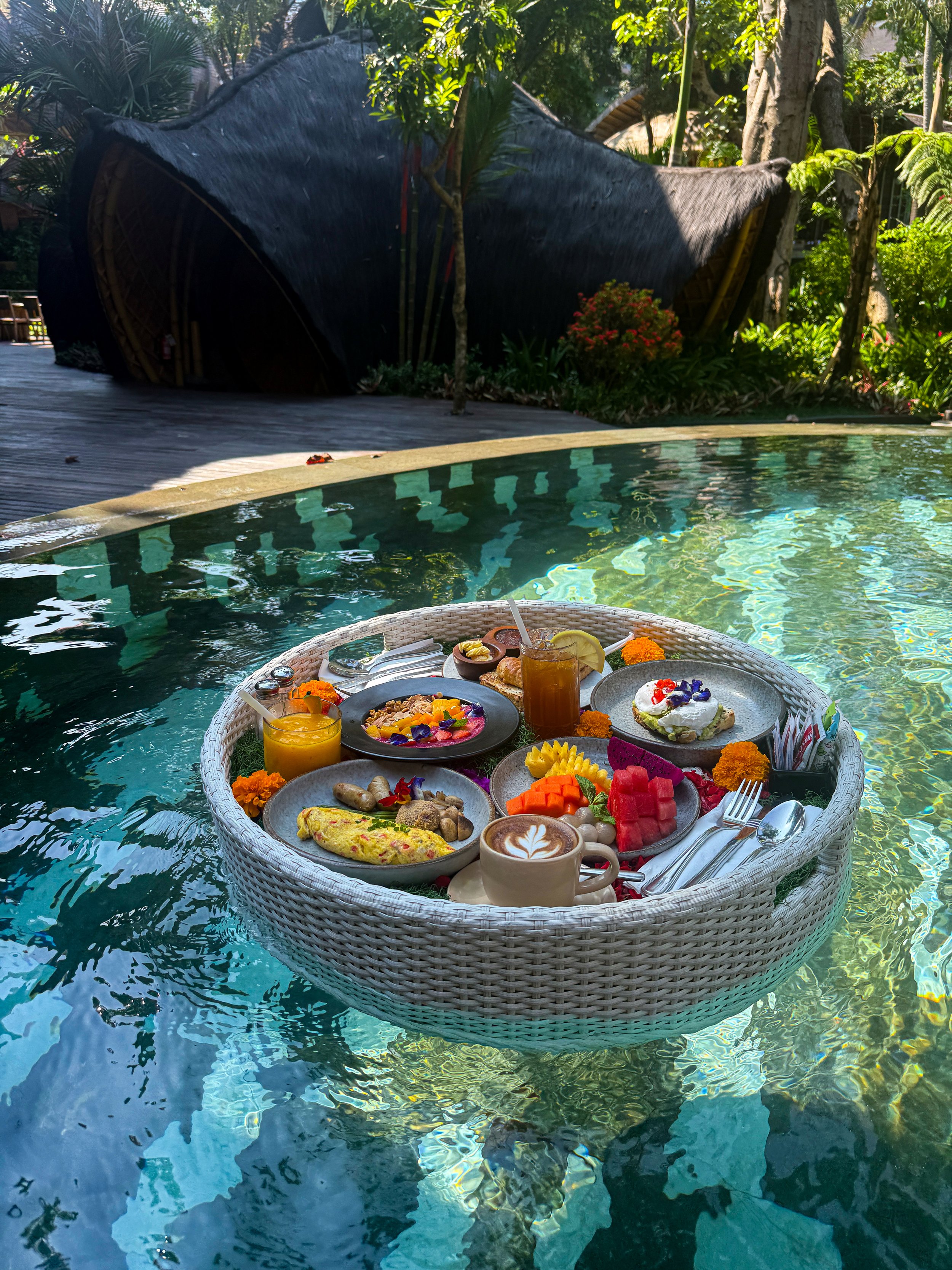 A floating breakfast served in the swimming pool features fresh tropical fruit, pastries, coffee, and Indonesian-inspired breakfast dishes