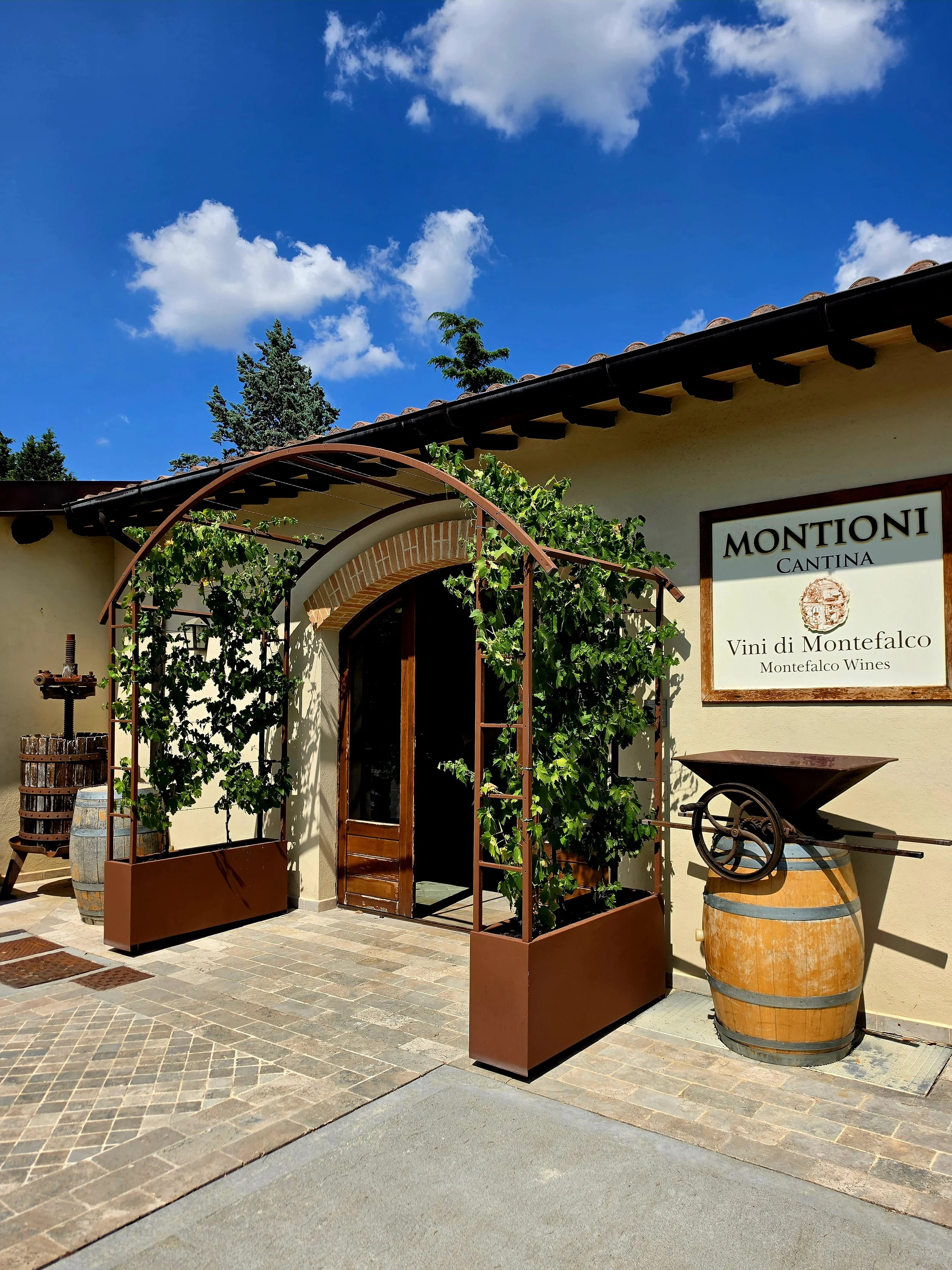 Entrance to a local winery surrounded by vineyards in the Umbrian countryside
