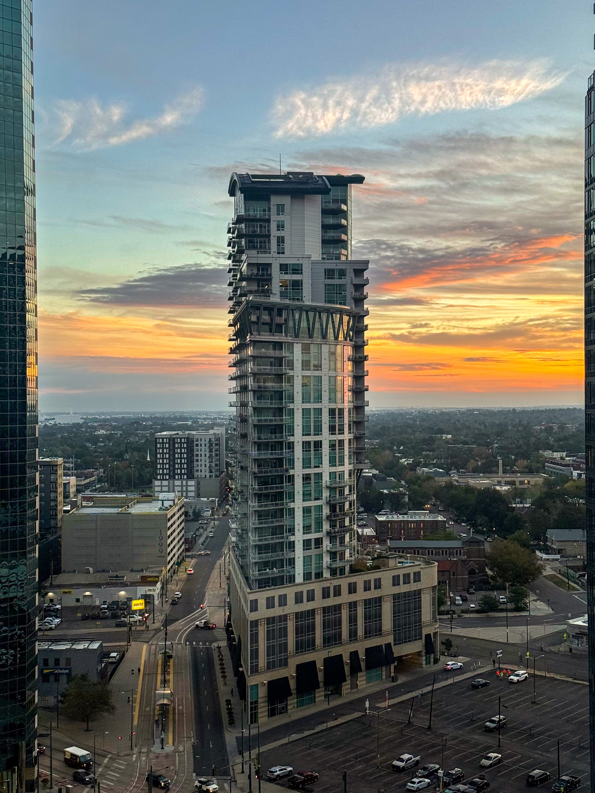 Panoramic downtown Denver skyline at sunset from a high-floor window