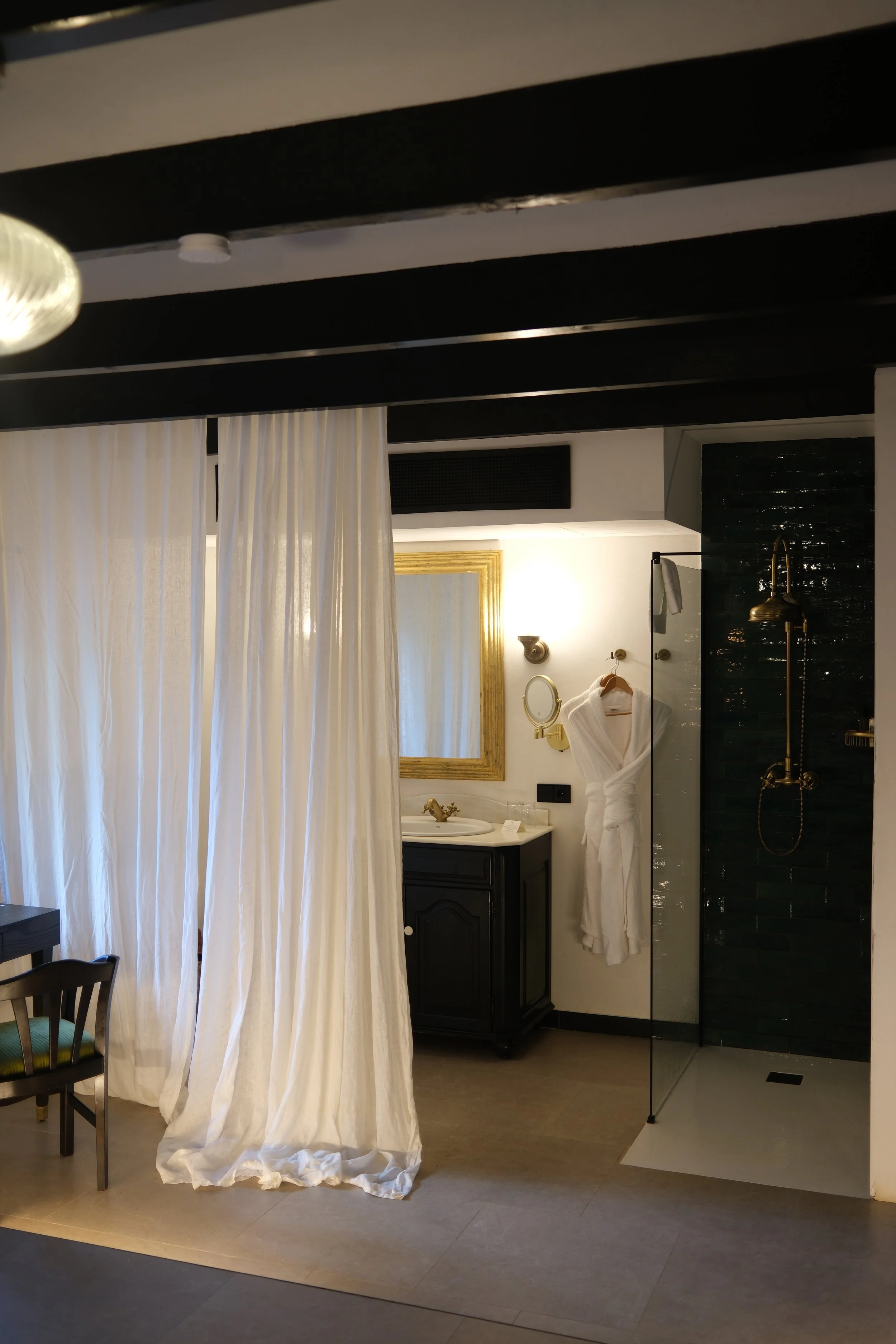 Open-concept suite bathroom with soft neutral tones at Son Molí Country House
