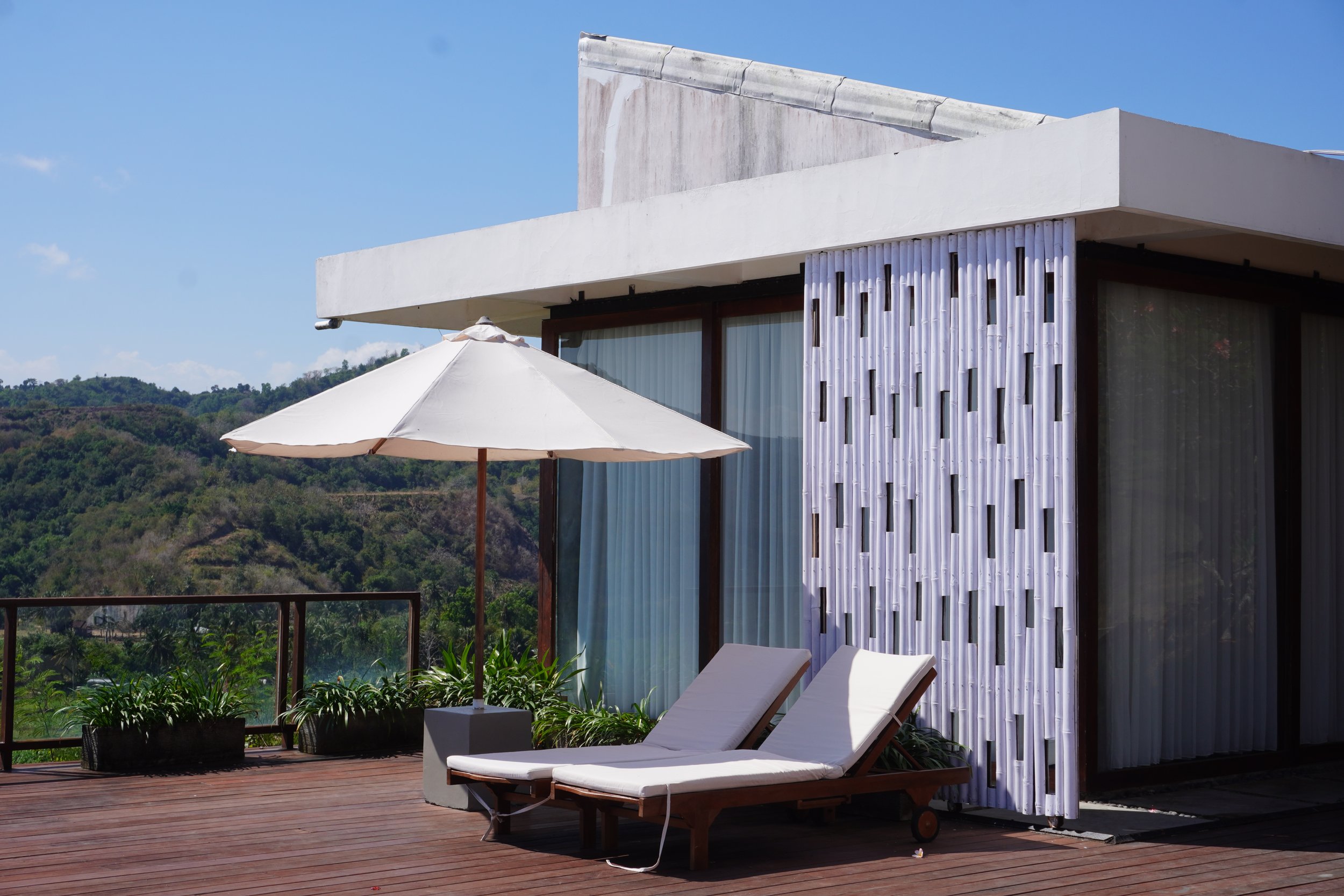 Sun loungers and spacious terrace with panoramic mountain scenery