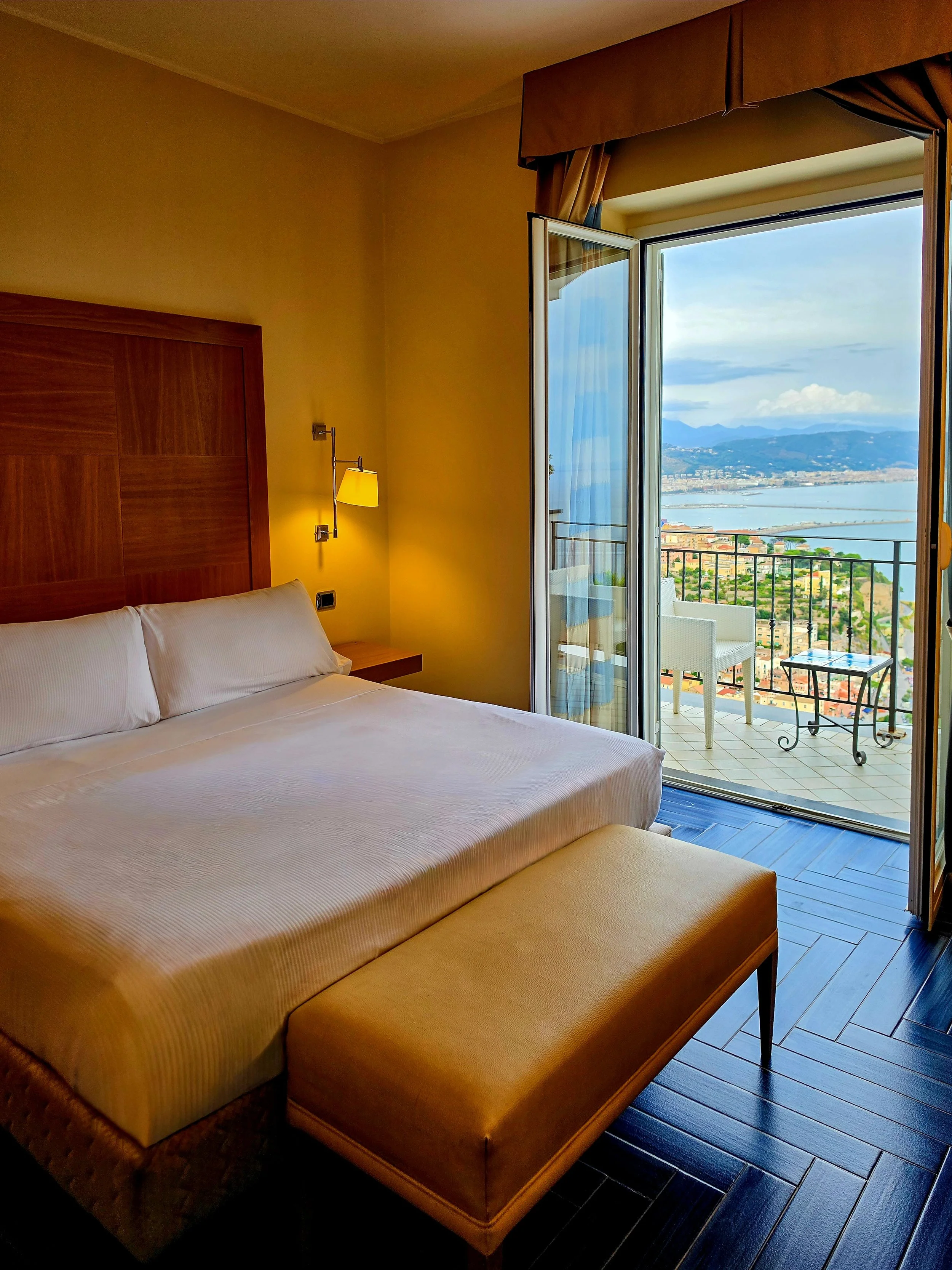 Elegant superior room view opening onto a private balcony overlooking the Amalfi Coast