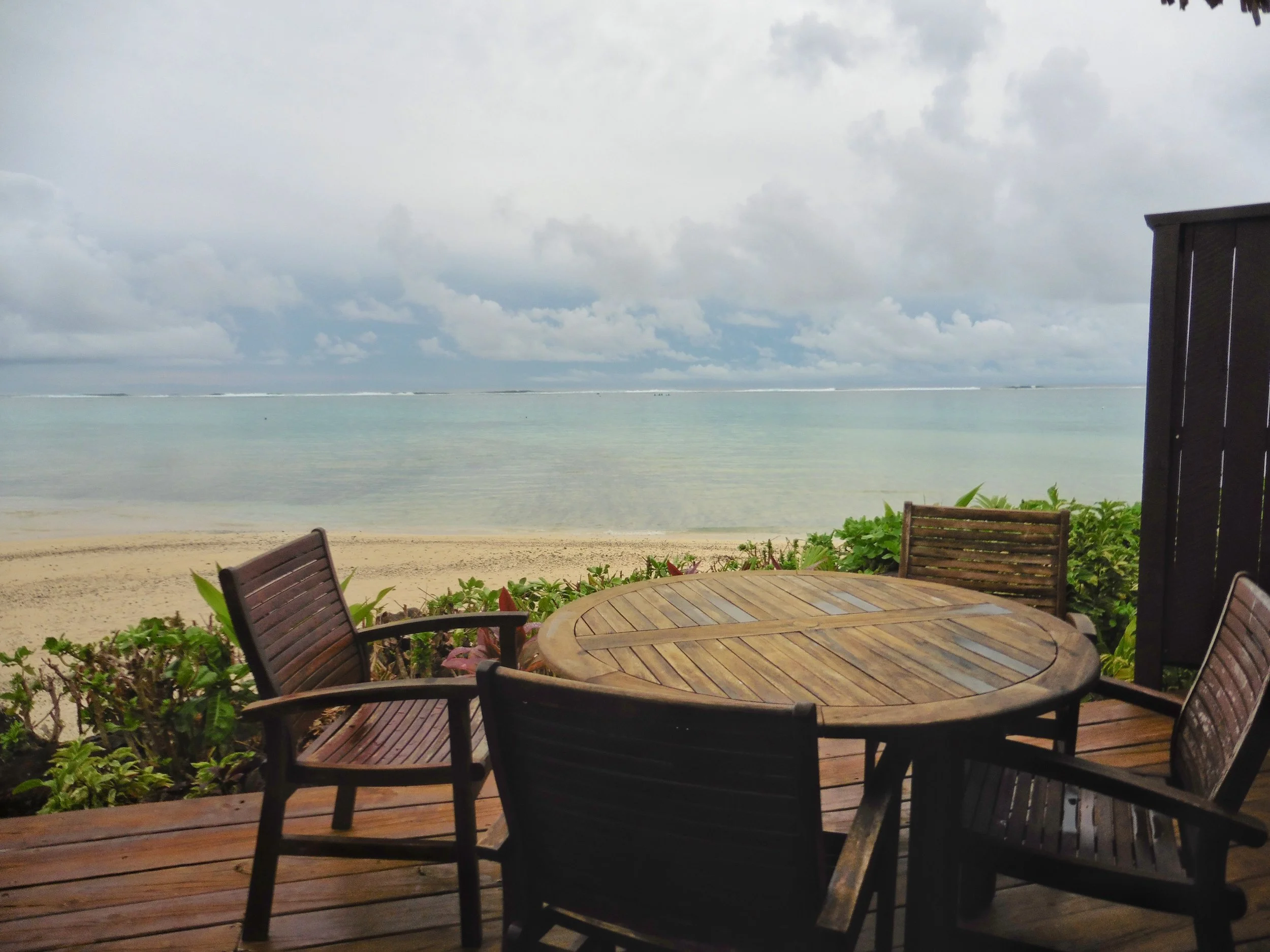 Oceanfront terrace with outdoor dining overlooking the lagoon at Sea Change Villas, Cook Islands