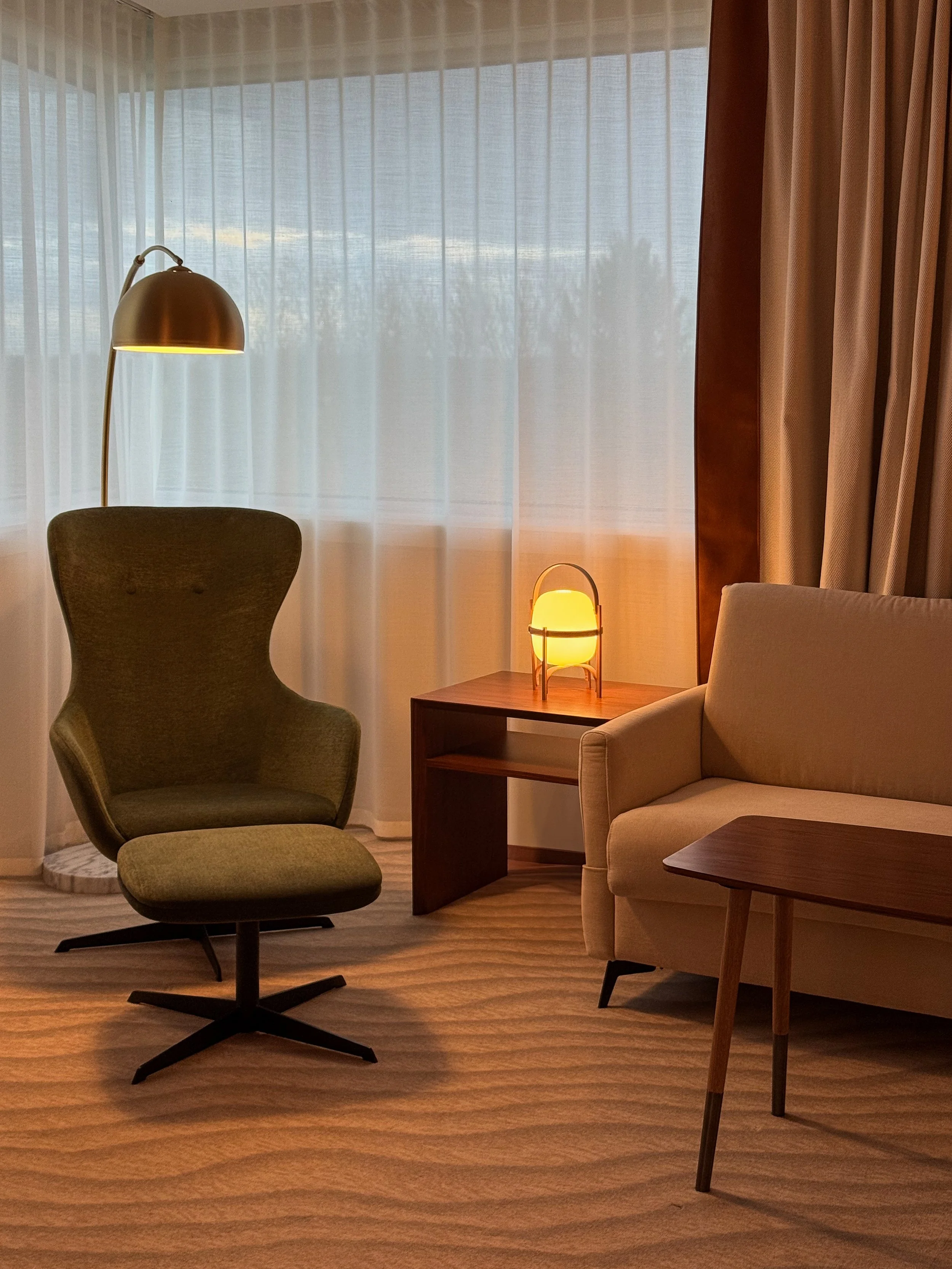 Elegant suite with contemporary furnishings, warm lighting, and refined French-inspired design