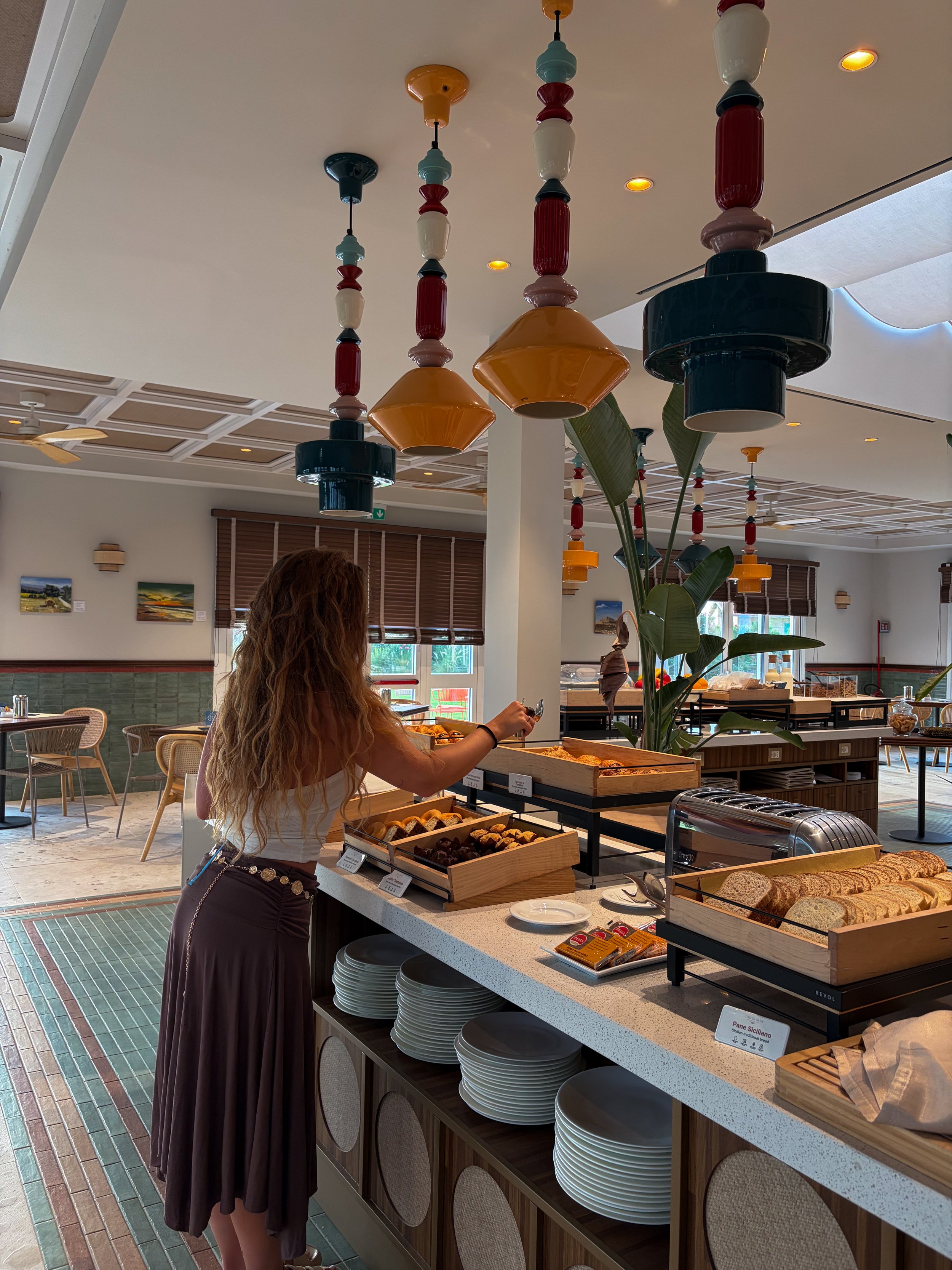Contemporary breakfast buffet showcasing fresh Sicilian pastries and local specialties