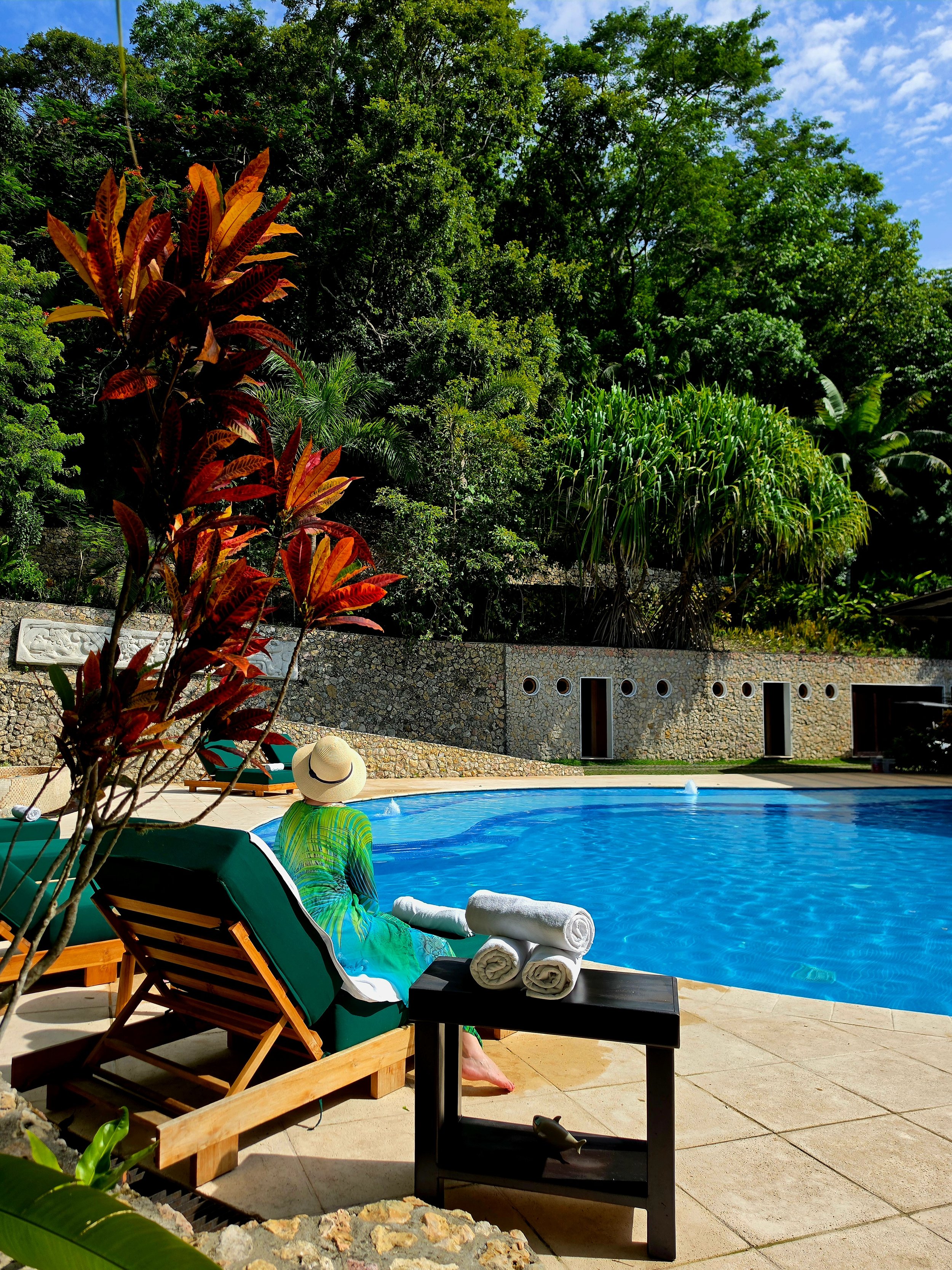 Relaxing poolside surrounded by lush jungle overlooking Lake Petén Itzá