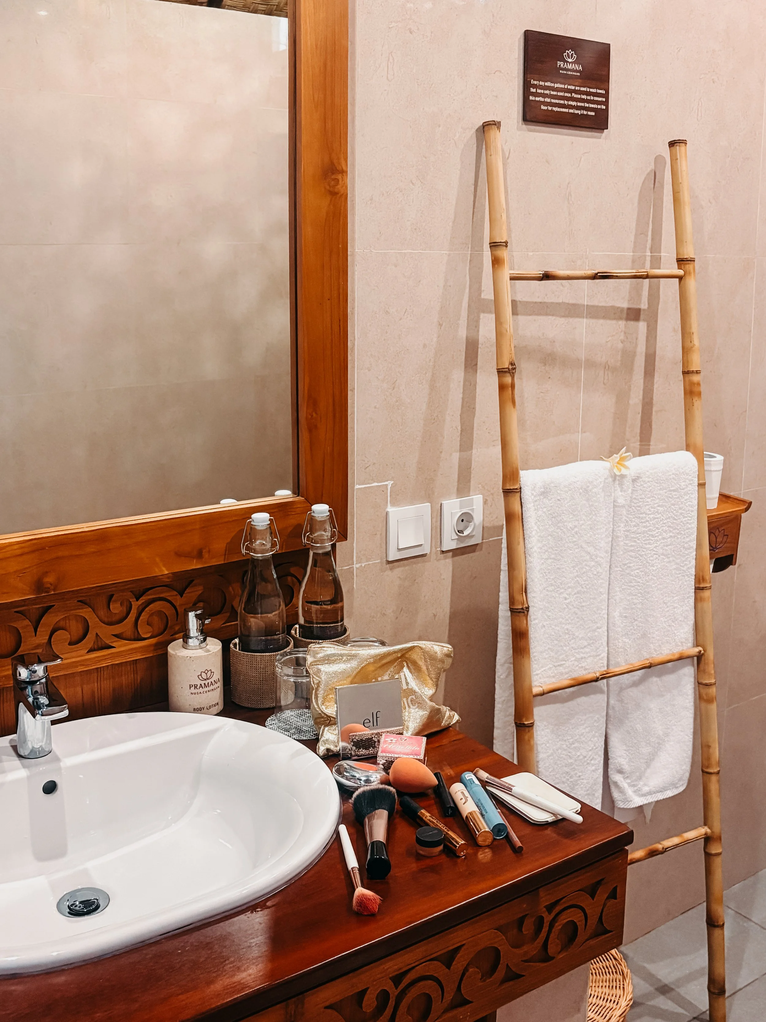 Image 4
Bathroom vanity with sink, bamboo towel ladder, and amenities in tropical villa at Pramana Nusa Ceningan Resort Bali
