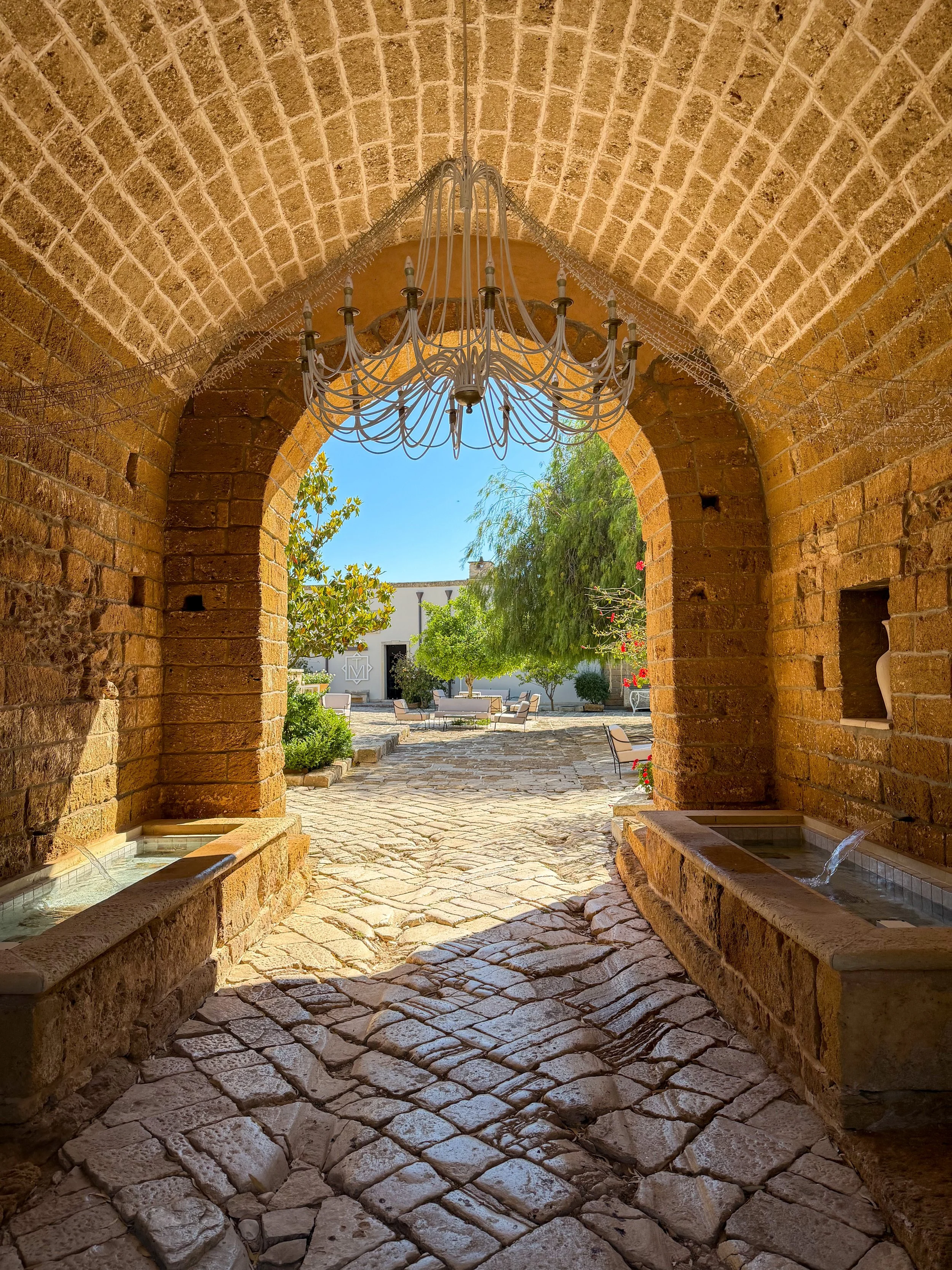 Historic stone archway leading into the heart of the estate at Tenuta Monacelli Lecce