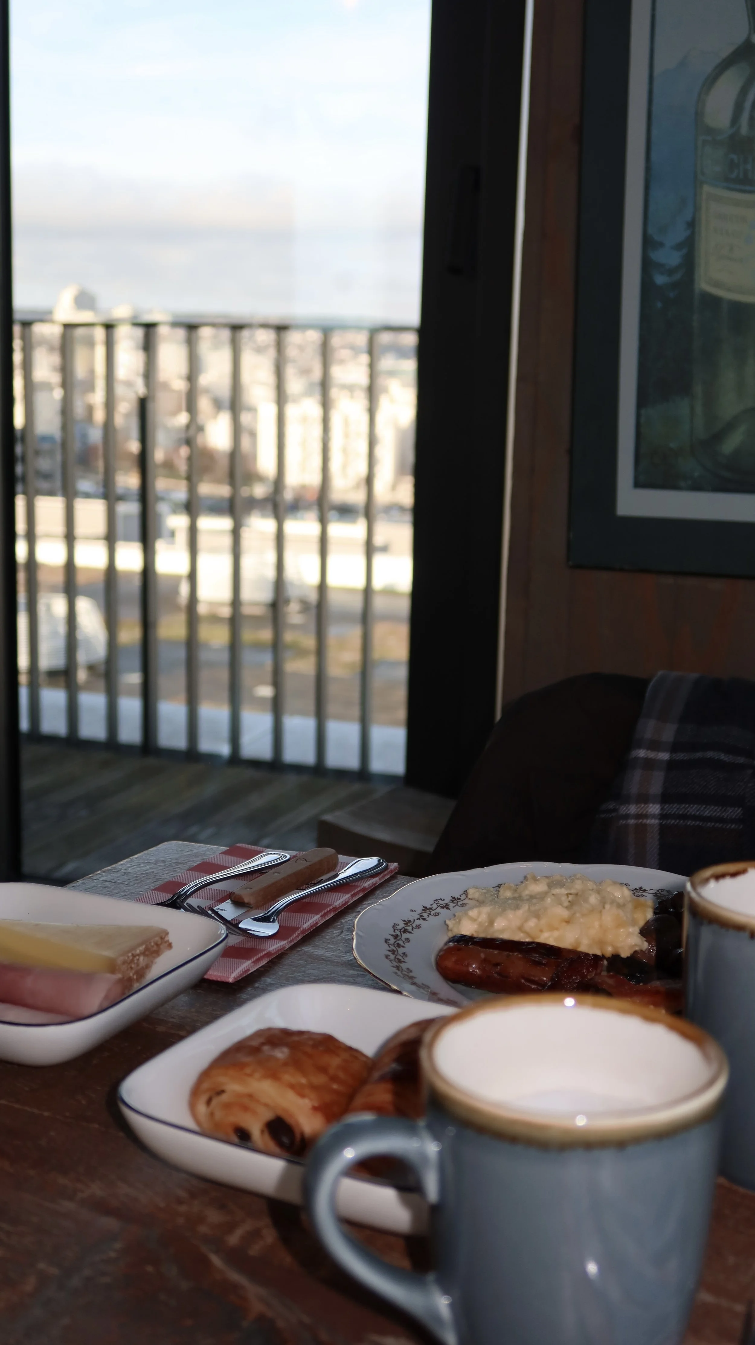 Breakfast table set with pastries and coffee beside a balcony view over Paris, Novotel Paris Porte de Versailles – Paris, France.