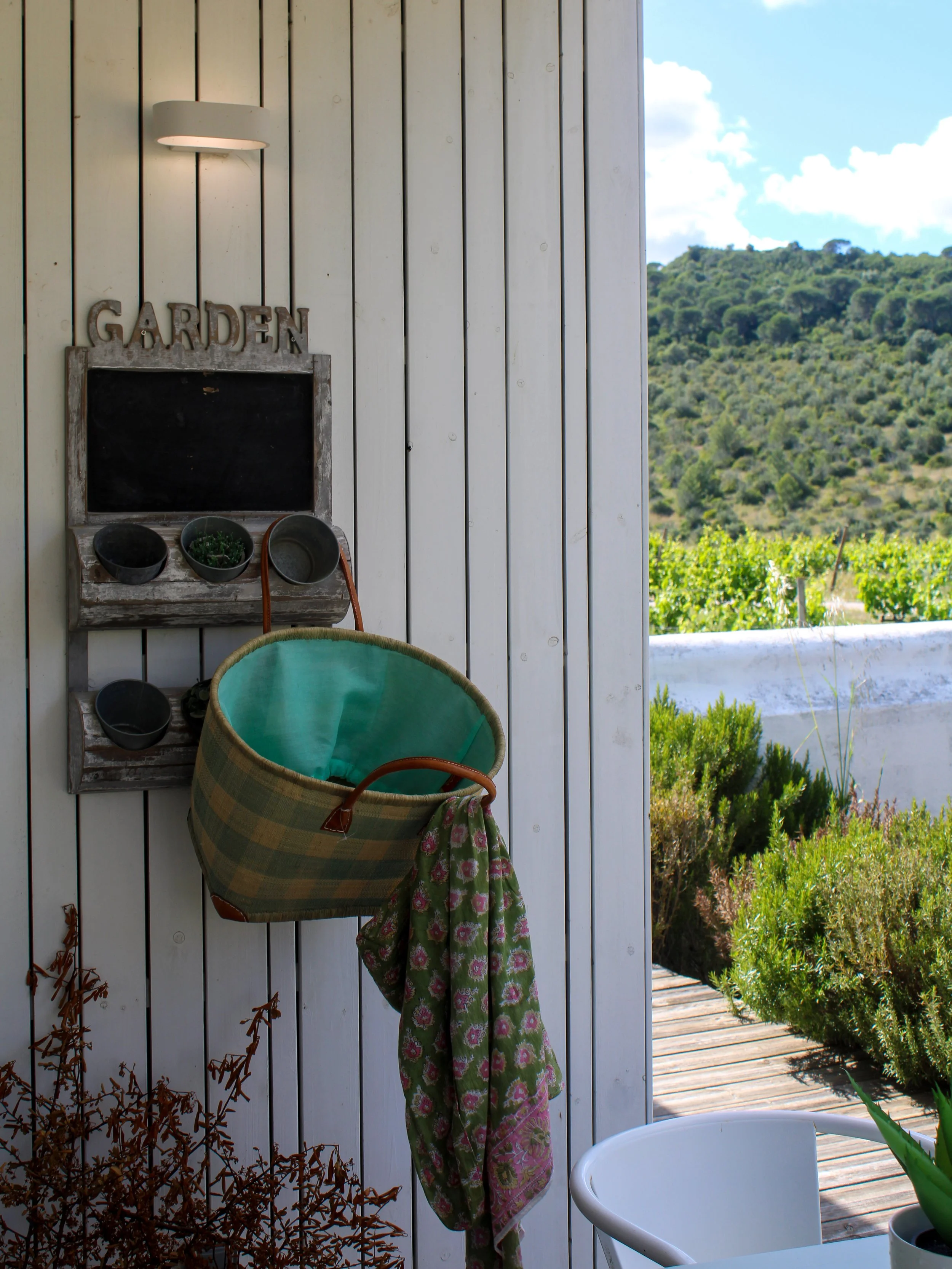 Garden pavilion with rustic details opening onto vineyards and landscaped grounds
