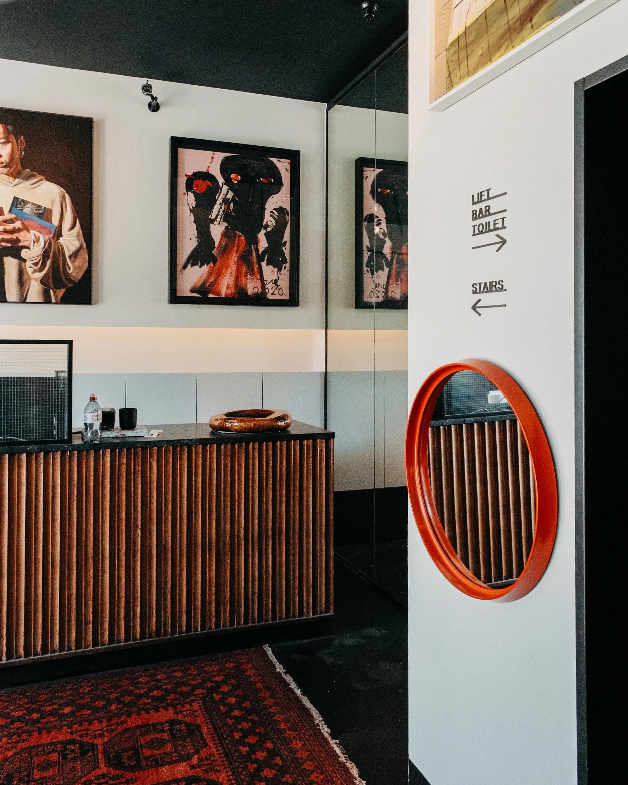 Contemporary reception with curated artwork, warm wood finishes, and modern design details