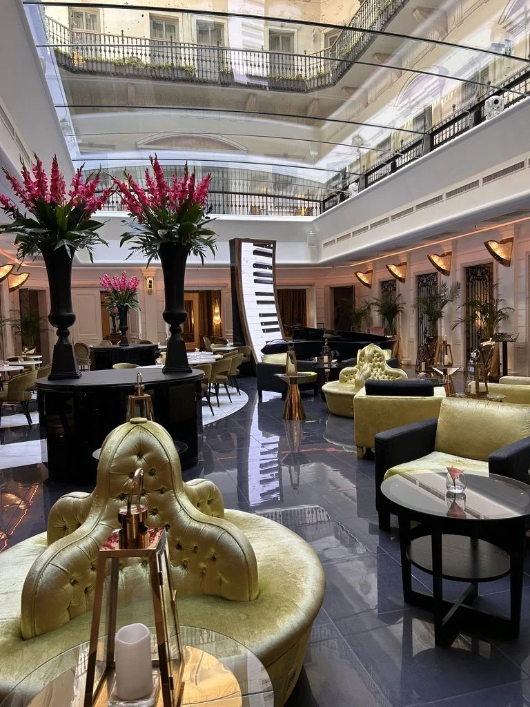 Sophisticated atrium lounge with grand piano and luxurious seating