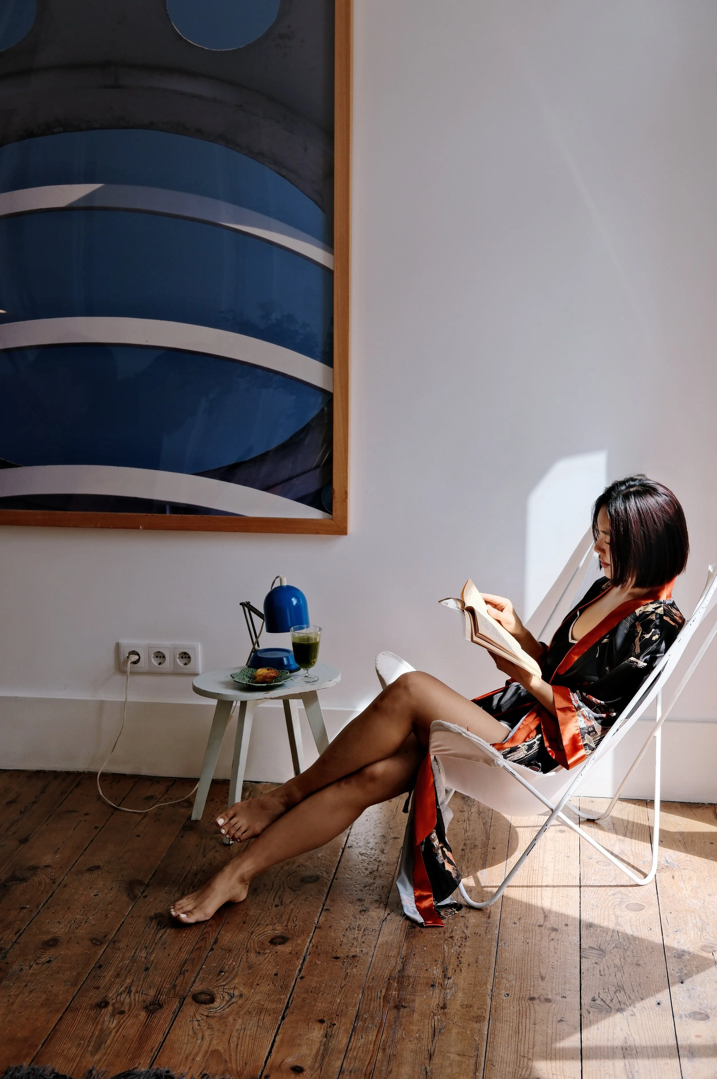 Quiet reading corner filled with natural light inside a stylish Lisbon apartment